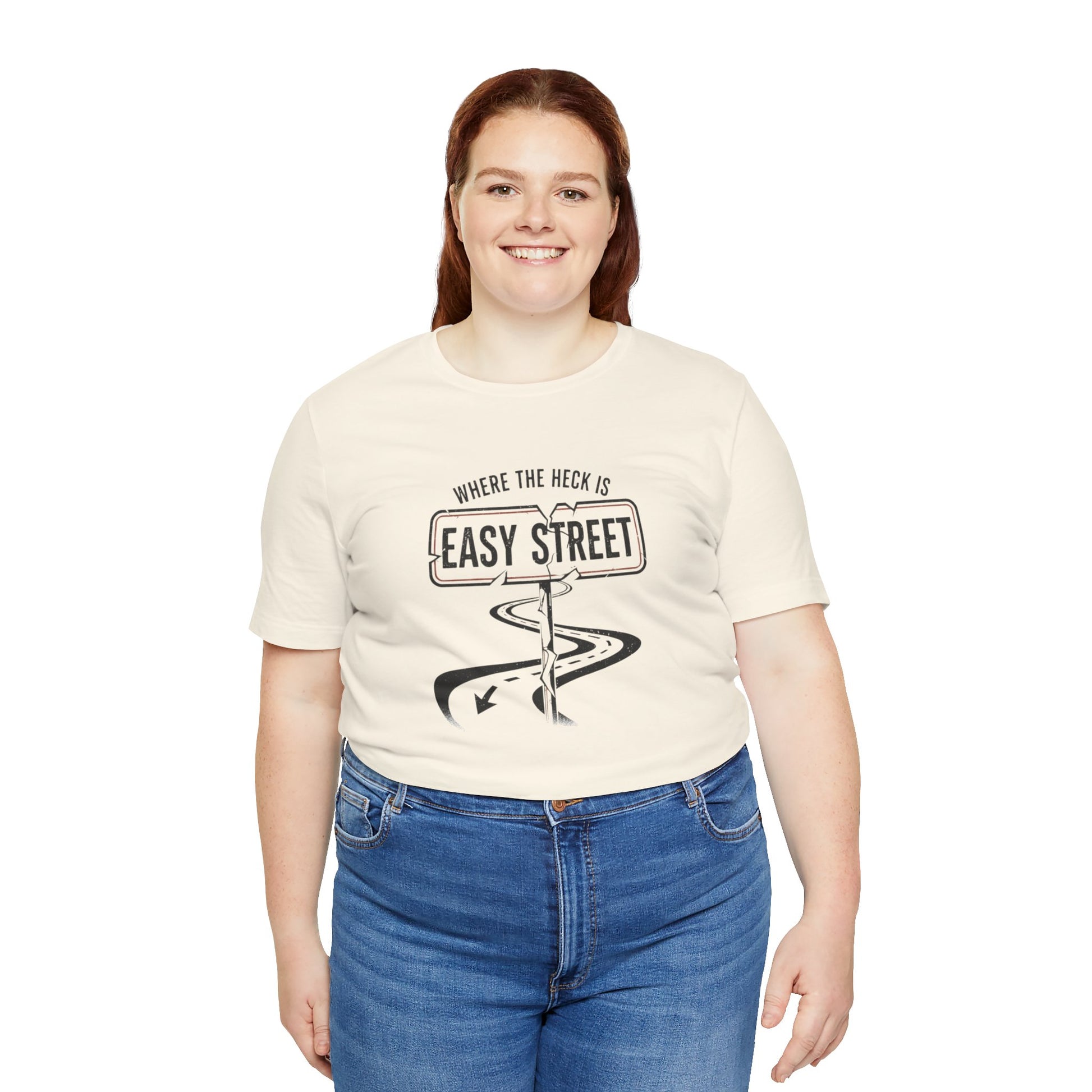 Person wearing a beige t-shirt with a graphic design and text 'Where the heck is Easy Street' on a white background
