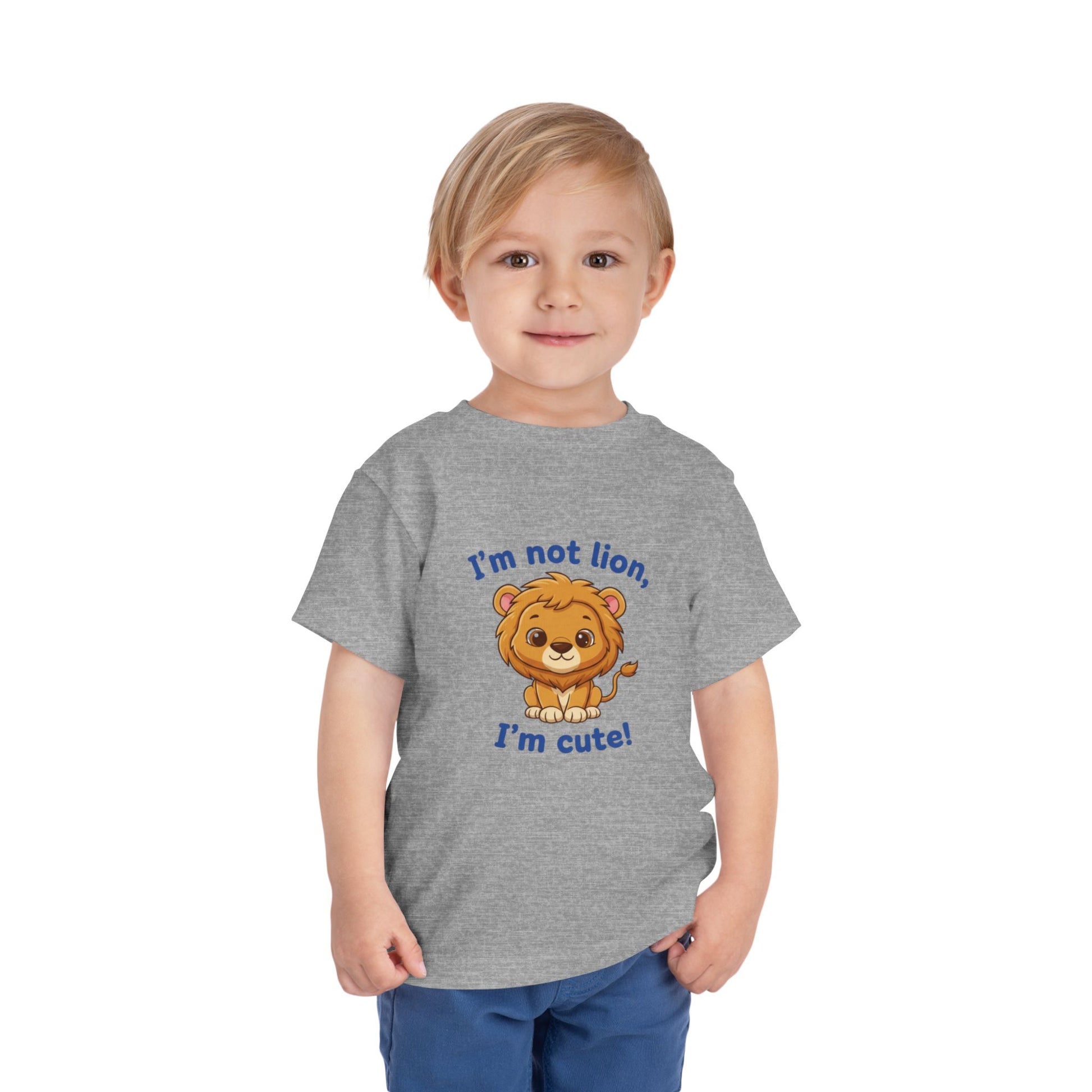 Child wearing an Athletic Heather t-shirt with a lion graphic and text "I'm Not Lion I'm Cute"  Bella+Canvas 3001T on a white background