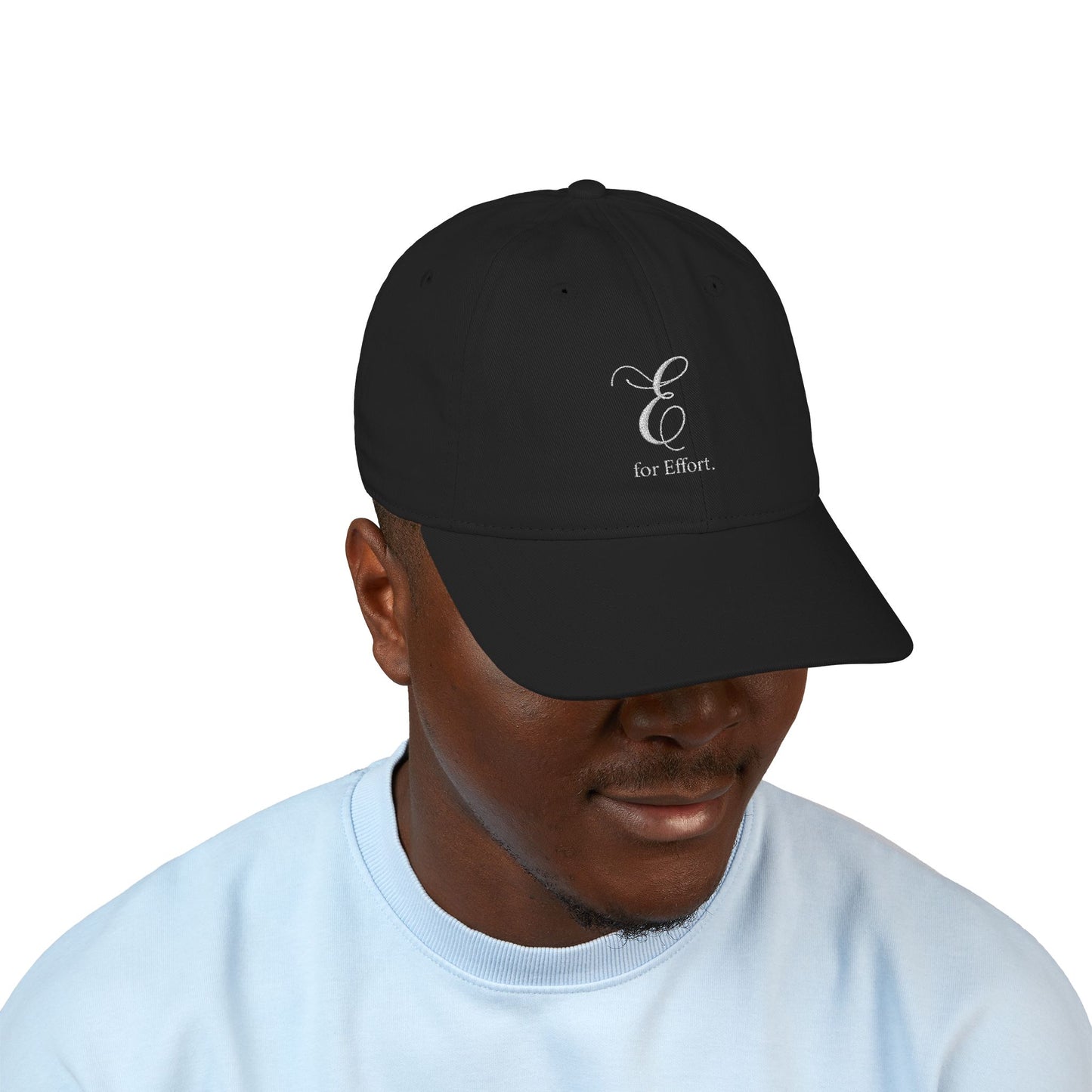 Person wearing a black cap with text 'E for Effort' on a white background