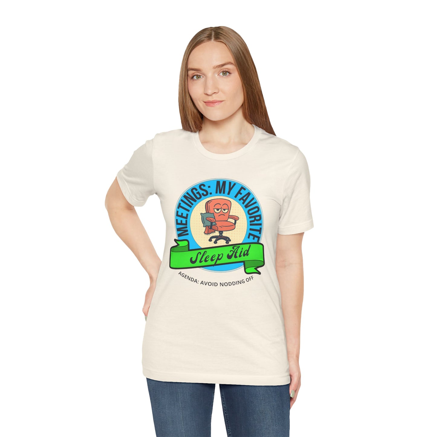 Woman wearing a cream t-shirt with a graphic design and text 'Meetings: My favorite sleep aid. Agenda: Avoid nodding off' on a white background