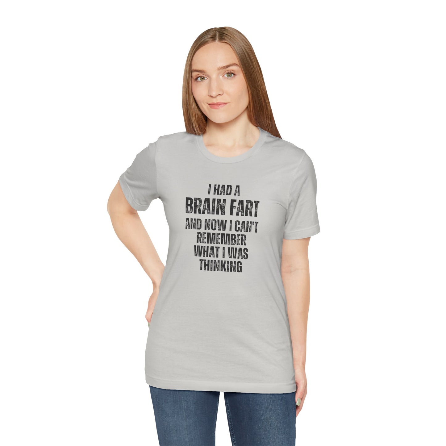 Woman wearing a gray t-shirt with humorous text 'I had a brain fart and now I can't remember what I was thinking' design on a white background