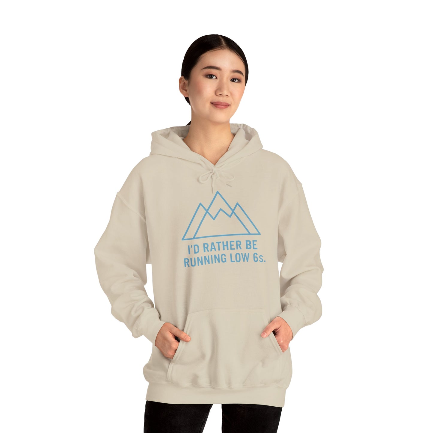 Person wearing a beige hoodie with blue text 'I'd rather be running low 6s' and mountain graphic on a white background