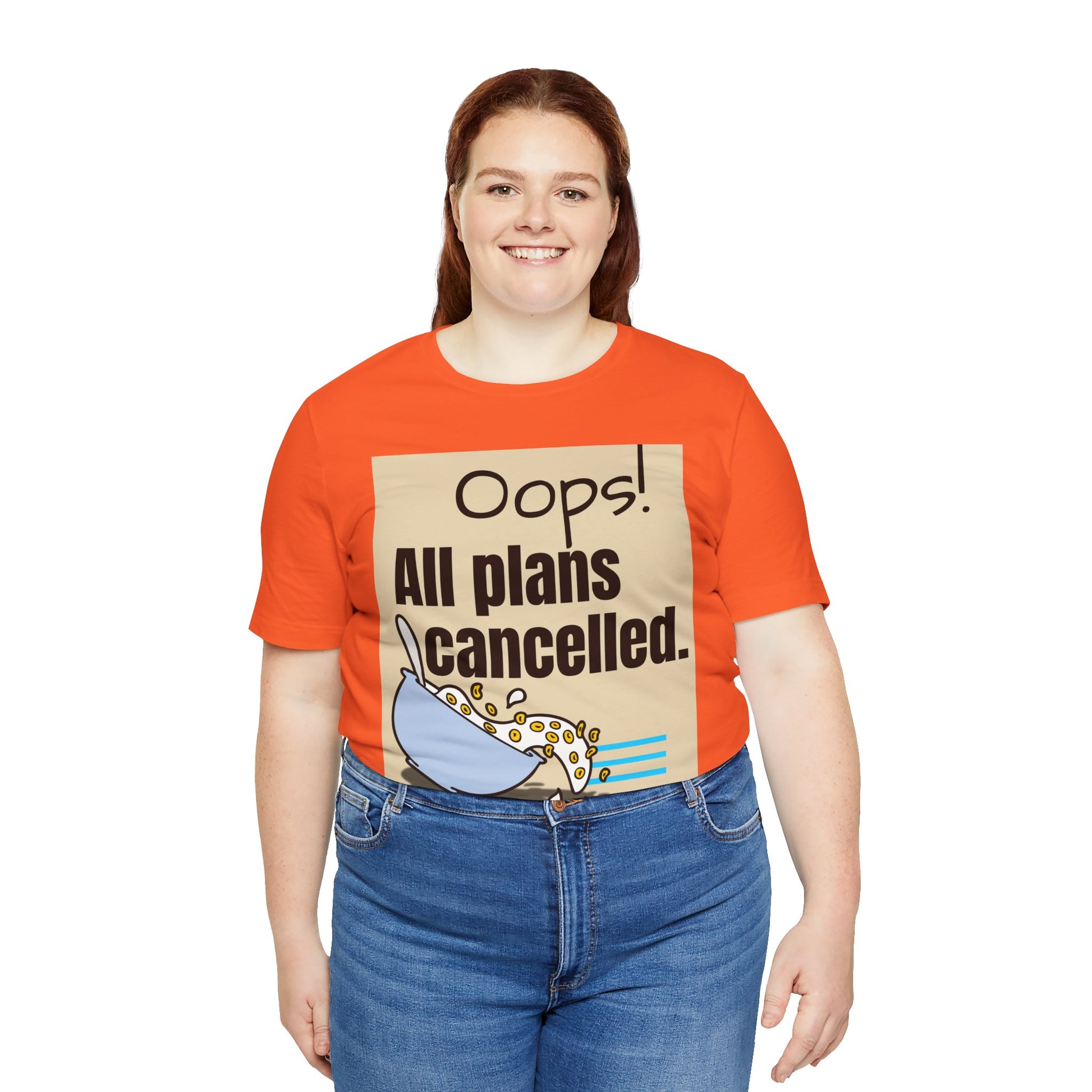 Person wearing an orange t-shirt with a graphic and text 'Oops! All plans cancelled.'