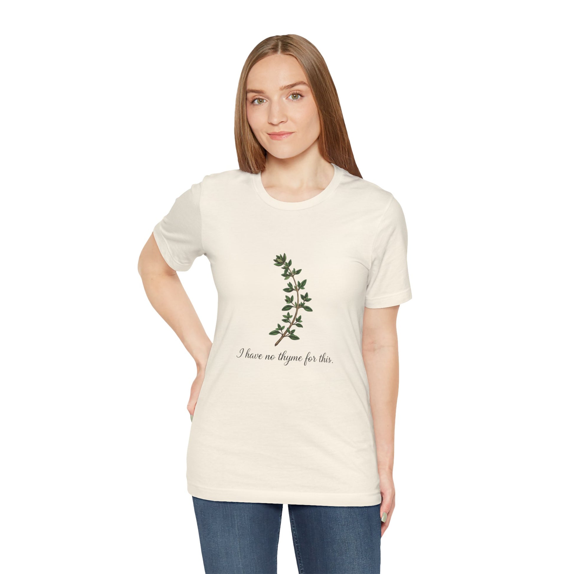 Woman wearing a white t-shirt with a plant design and text 'I have no thyme for this' on a white background