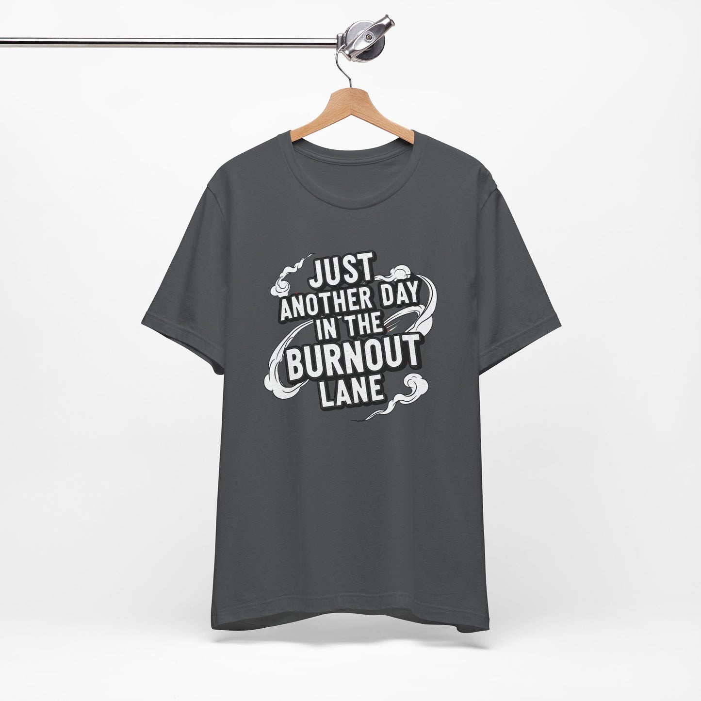 Gray t-shirt with text 'Just another day in the burnout lane' on a hanger against a white background