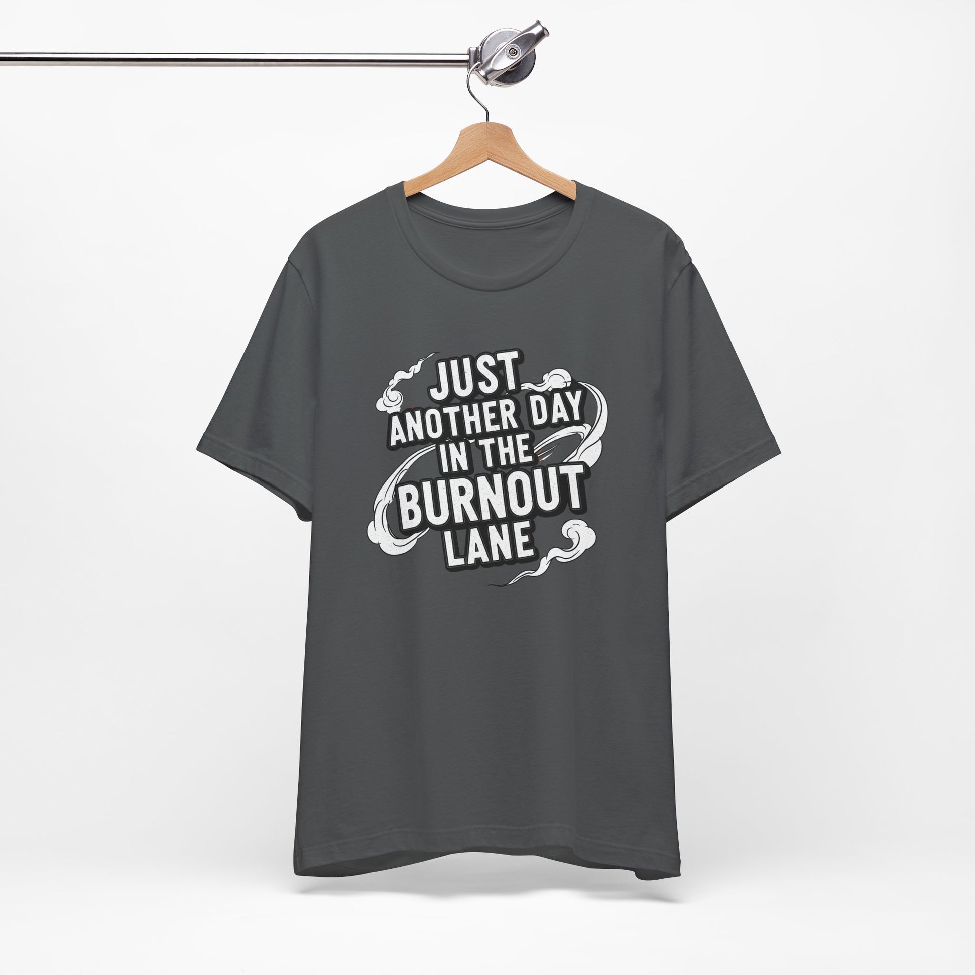 Gray t-shirt with text 'Just another day in the burnout lane' on a hanger against a white background
