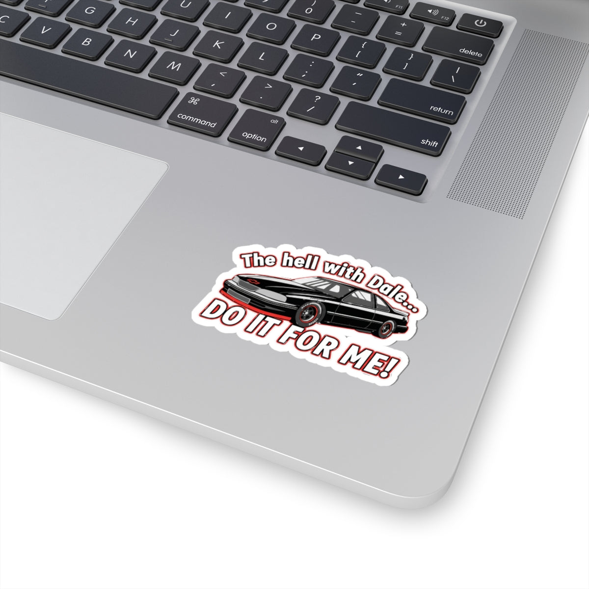 Laptop with a sticker featuring a car and text 'The hell with Dale Do it for me' on the palm rest area.