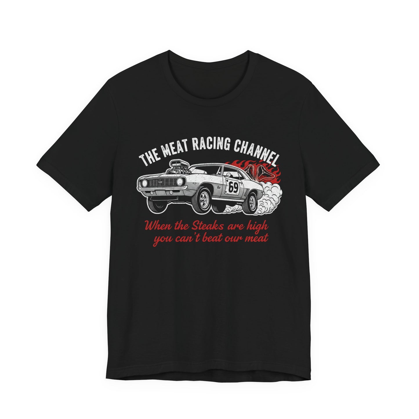 Black Bella+Canvas 3001 T‑shirt with a bold graphic design. The print features a vintage muscle car with the number 69, white smoke and red flames, the distressed white title “The Meat Racing Channel” above, and the red script tagline “When the Steaks are high you can’t beat our meat” below. Funny drag racing parody shirt with retro hot rod style graphics.