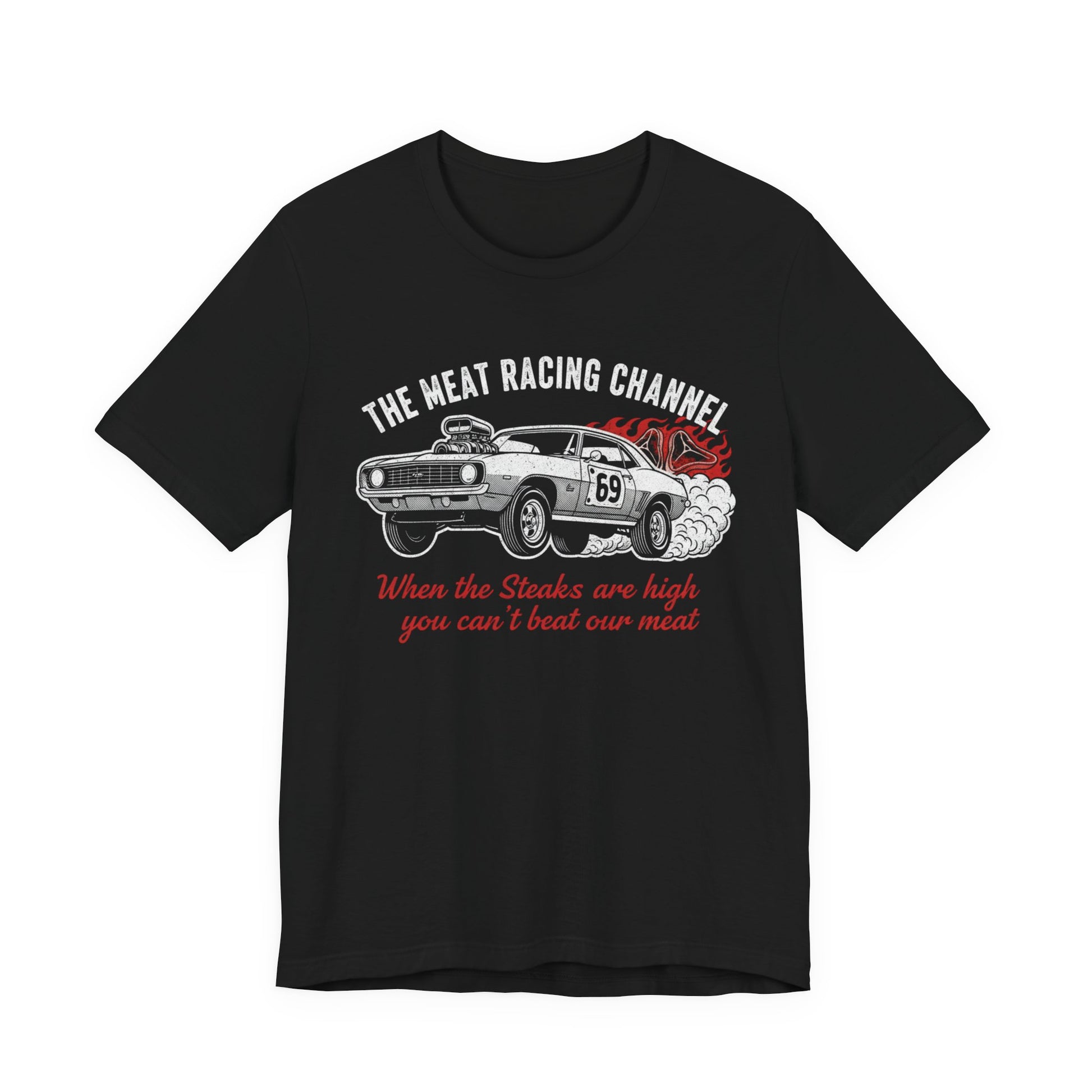 Black Bella+Canvas 3001 T‑shirt with a bold graphic design. The print features a vintage muscle car with the number 69, white smoke and red flames, the distressed white title “The Meat Racing Channel” above, and the red script tagline “When the Steaks are high you can’t beat our meat” below. Funny drag racing parody shirt with retro hot rod style graphics.