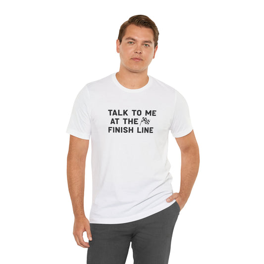 Man wearing a white t-shirt with text 'Talk to me at the finish line' on a white background