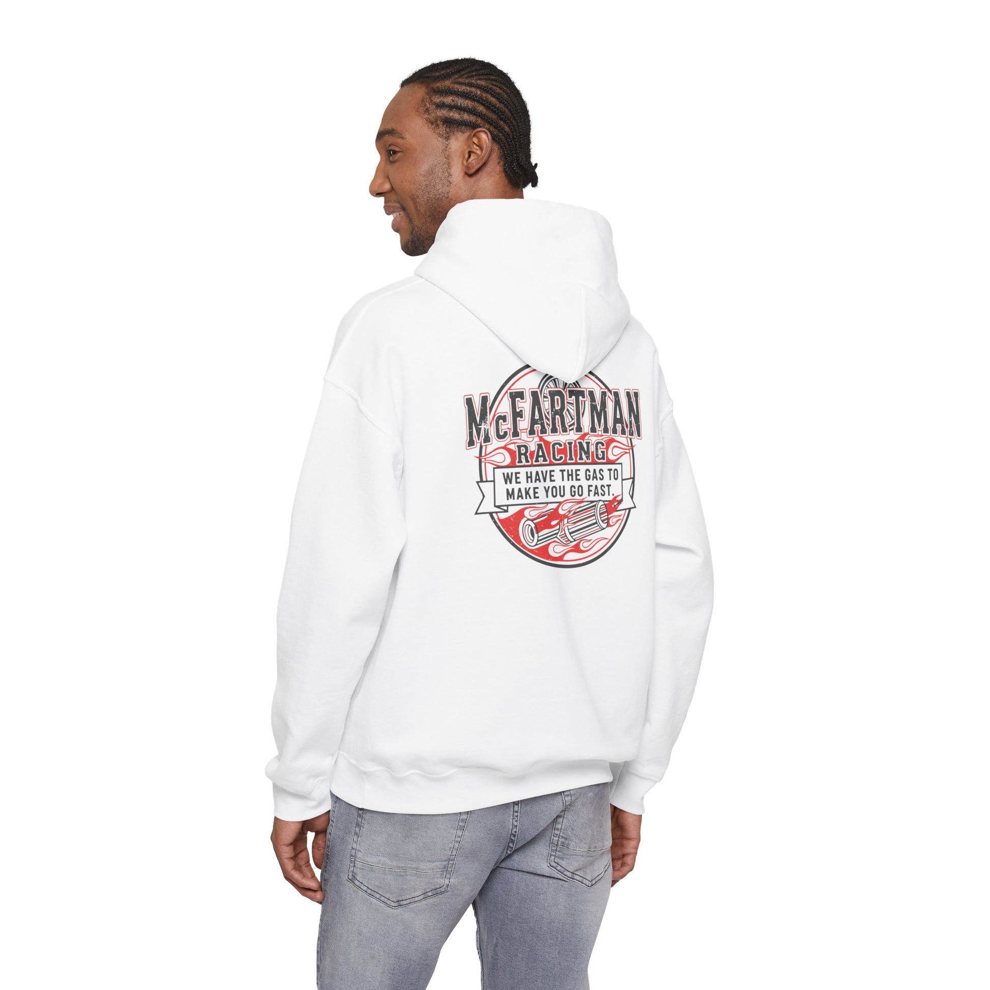 Person wearing a white hoodie with a graphic design McFartman Racing We have the gas to make you go fast on the back, standing against a white background