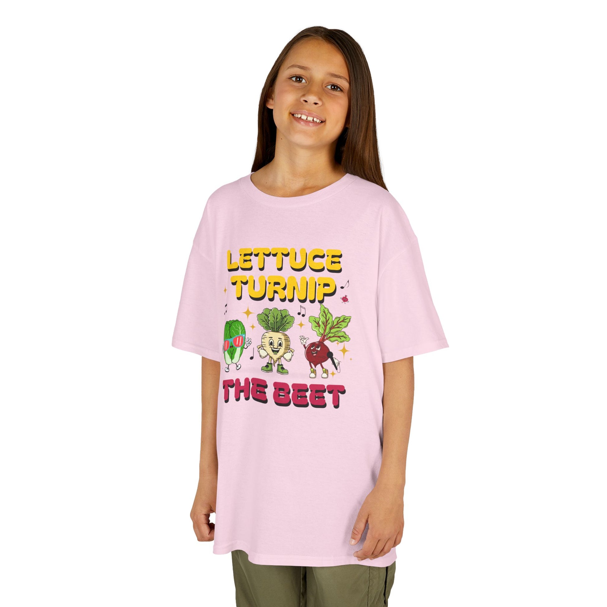 Child wearing a pink t-shirt with vegetable graphics and text 'Lettuce Turnip the Beet' on a white background