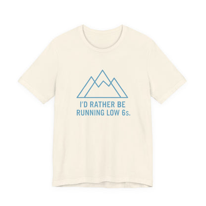 Beige t-shirt with blue mountain graphic and text 'I'd rather be running low 6s' on a white background