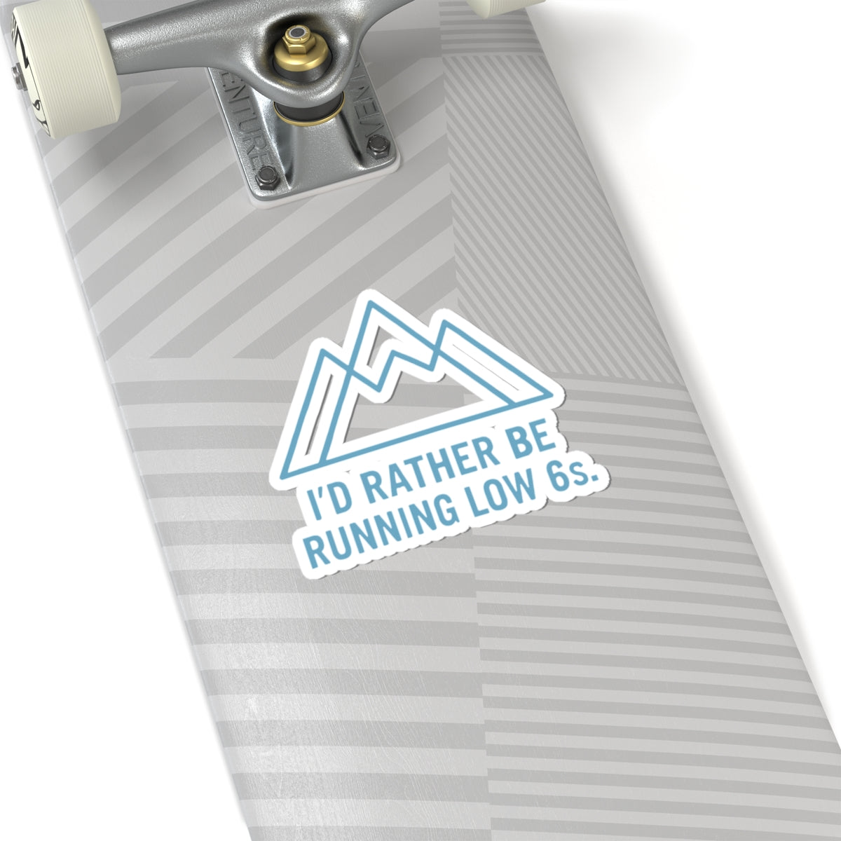 Skateboard deck with a sticker reading 'I'd rather be running low 6s.' on a white background