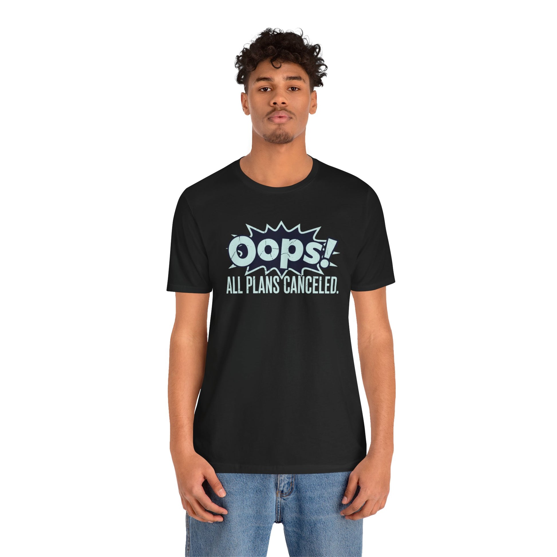 Person wearing a black t-shirt with 'Oops! All Plans Canceled' text on a white background