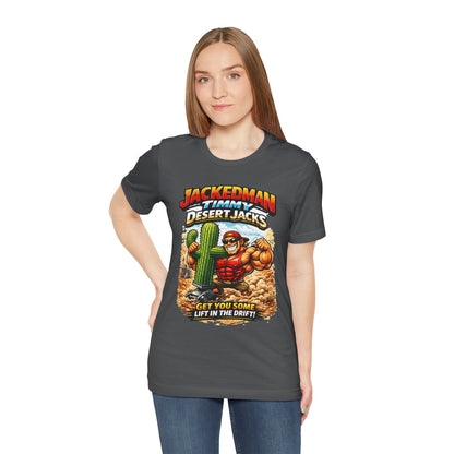 Person wearing a gray t-shirt with a graphic design featuring a muscular character, cactus, and 'Jackedman Timmy Desert Jacks Get You Some Lift In The Drift' text.