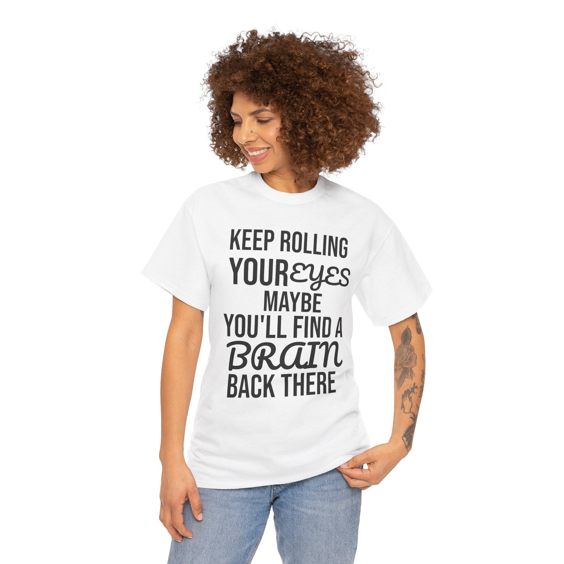 Woman wearing a white t-shirt with humorous text 'KEEP ROLLING YOUR EYES MAYBE YOU'LL FIND A BRAIN BACK THERE' design on a white background