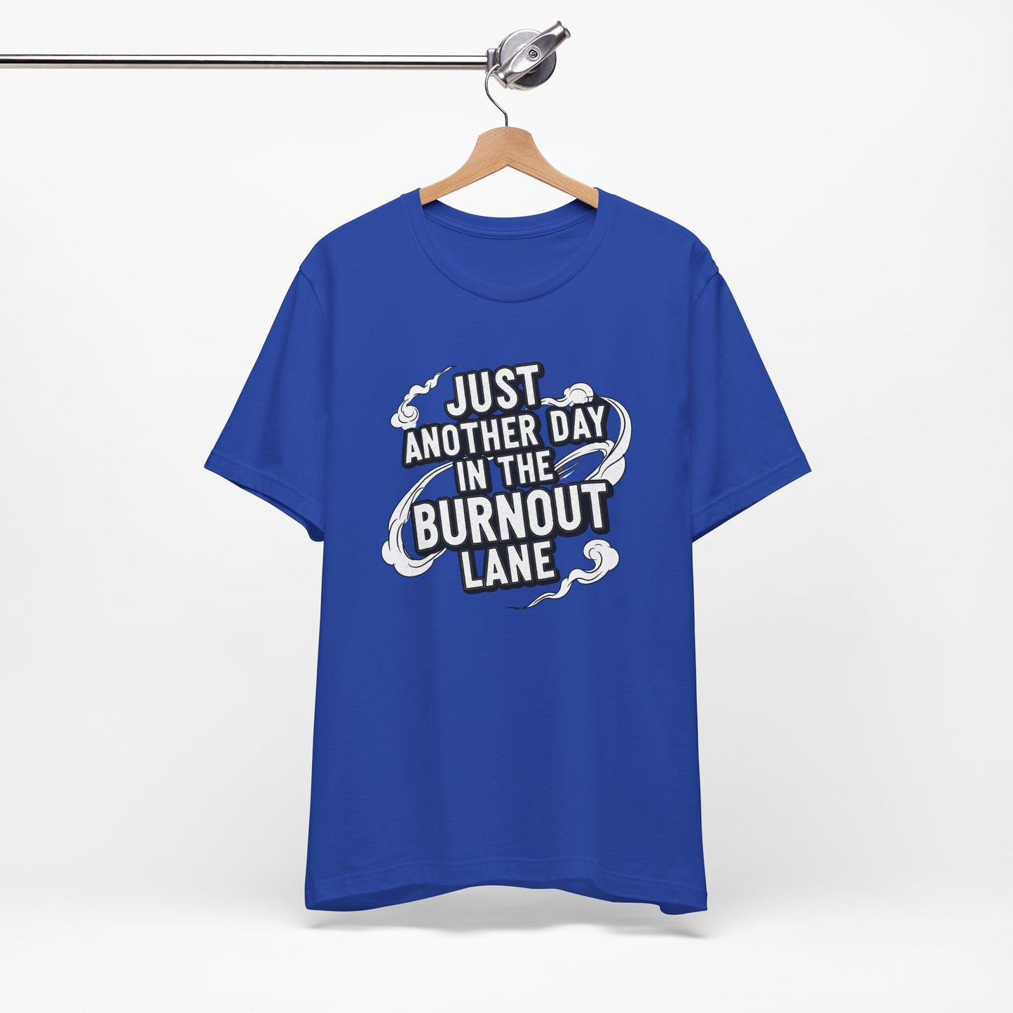 Blue t-shirt with text 'Just another day in the burnout lane' on a hanger against a white background