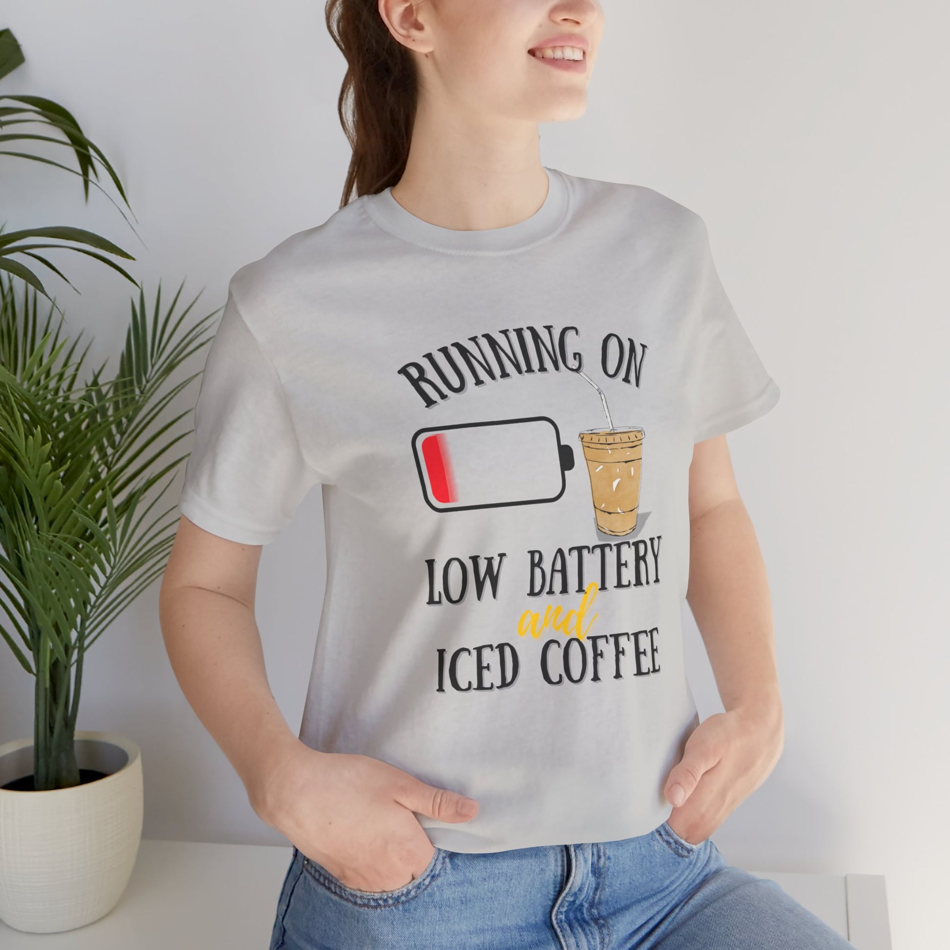 Person wearing a t-shirt with a humorous design about iced coffee.