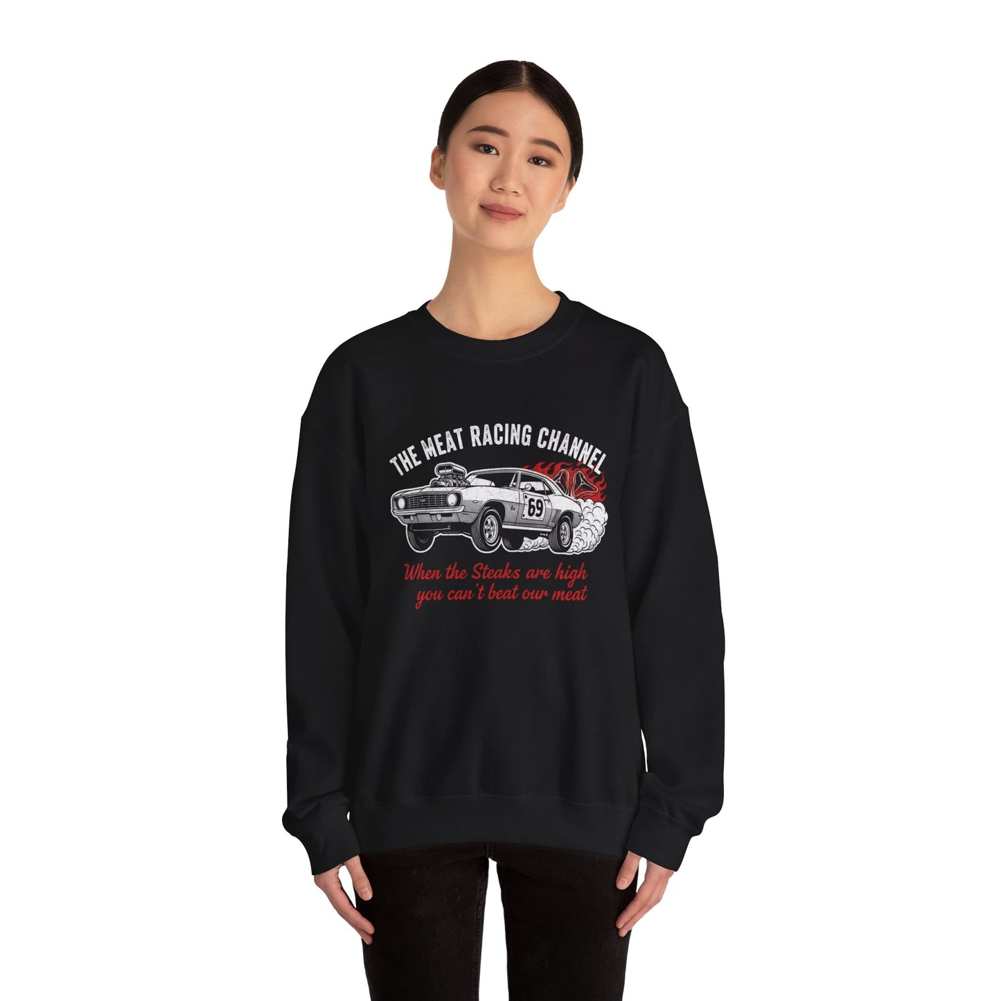 Person wearing a black sweatshirt with a car graphic and text 'The Meat Racing Channel When the Steaks are high you can't beat our meat' on a white background