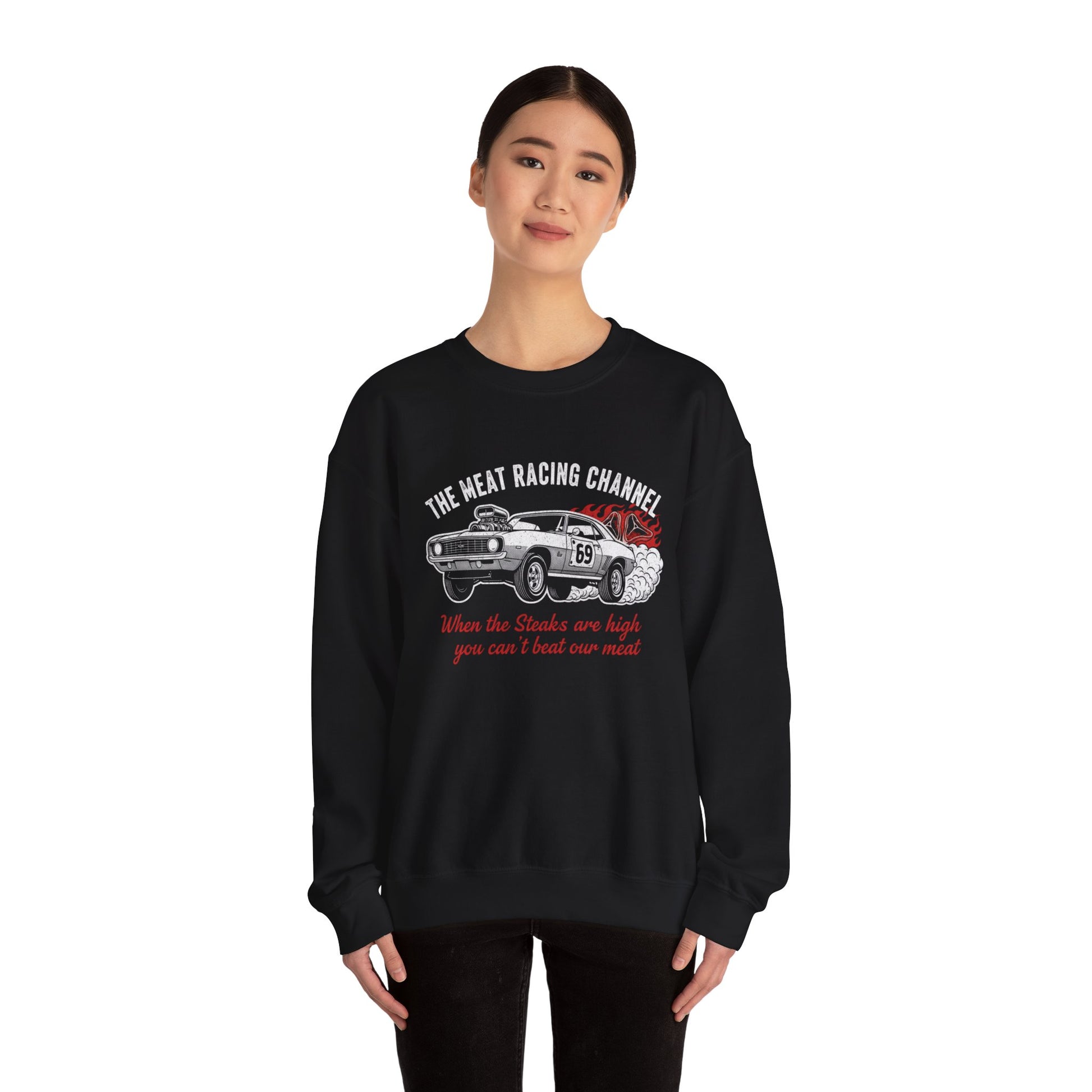 Person wearing a black sweatshirt with a car graphic and text 'The Meat Racing Channel When the Steaks are high you can't beat our meat' on a white background