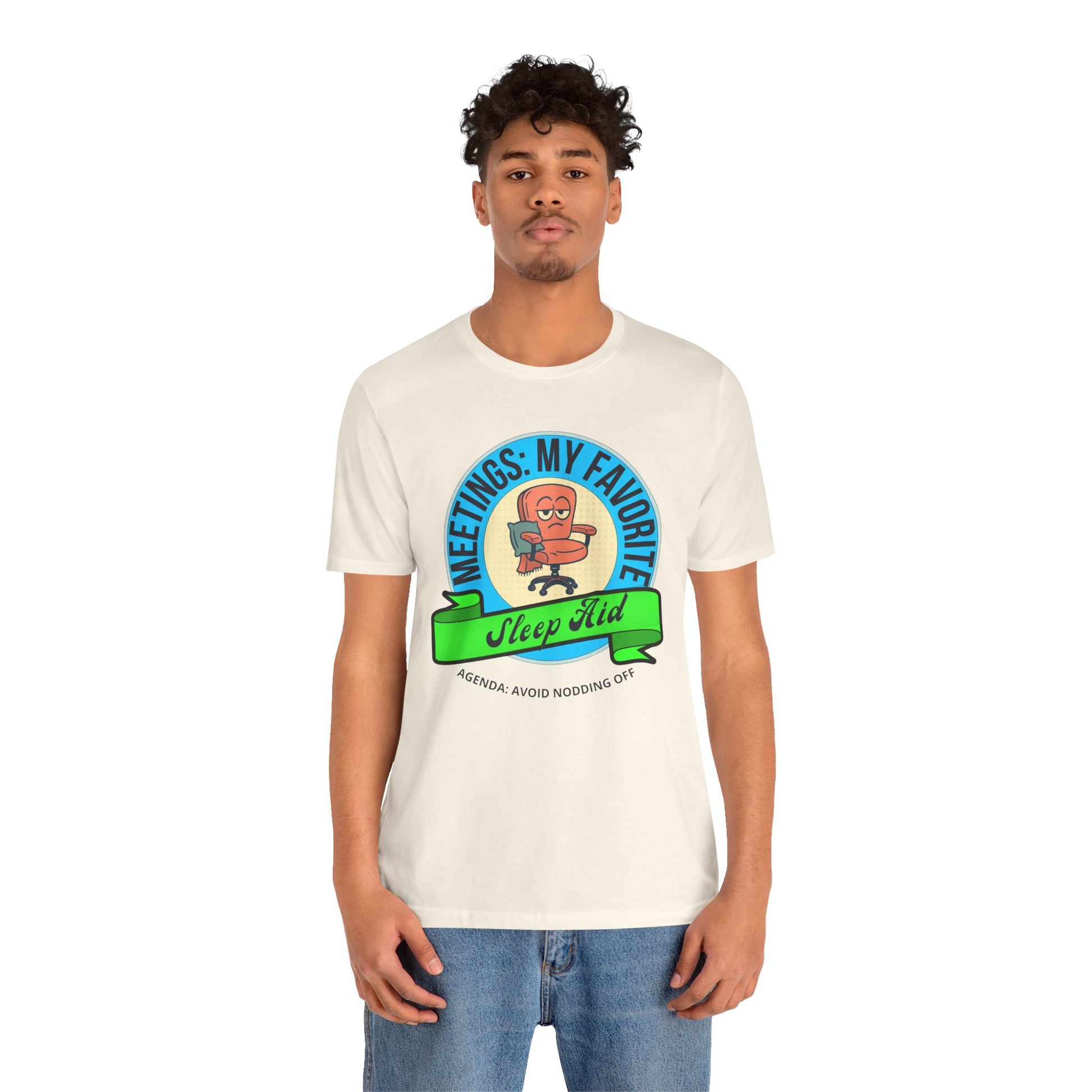 Person wearing a white t-shirt with a graphic design and text 'Meetings: My favorite sleep aid. Agenda: Avoid nodding off' on a white background
