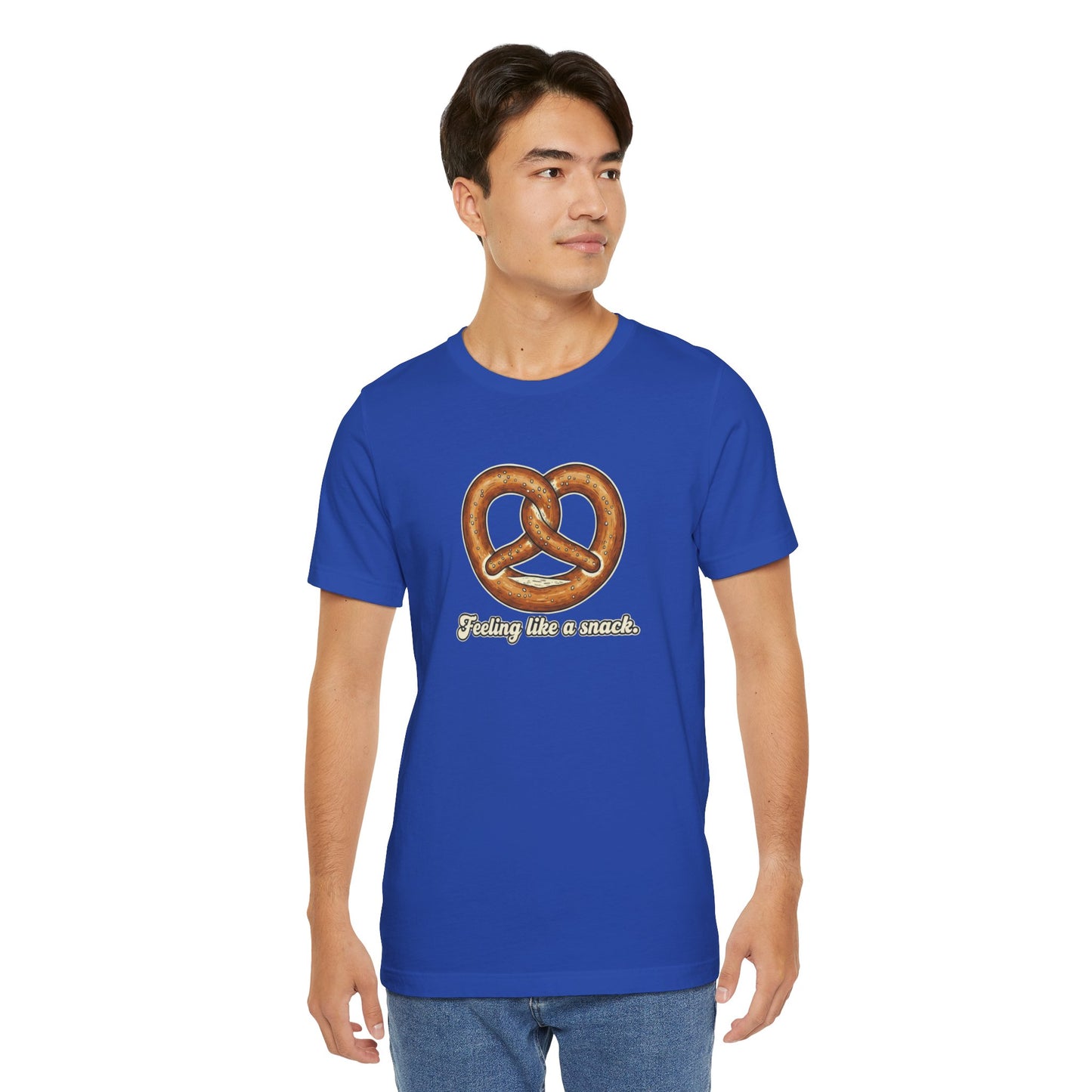 Man wearing a blue t-shirt with a pretzel graphic and text 'Feeling like a snack' on a white background