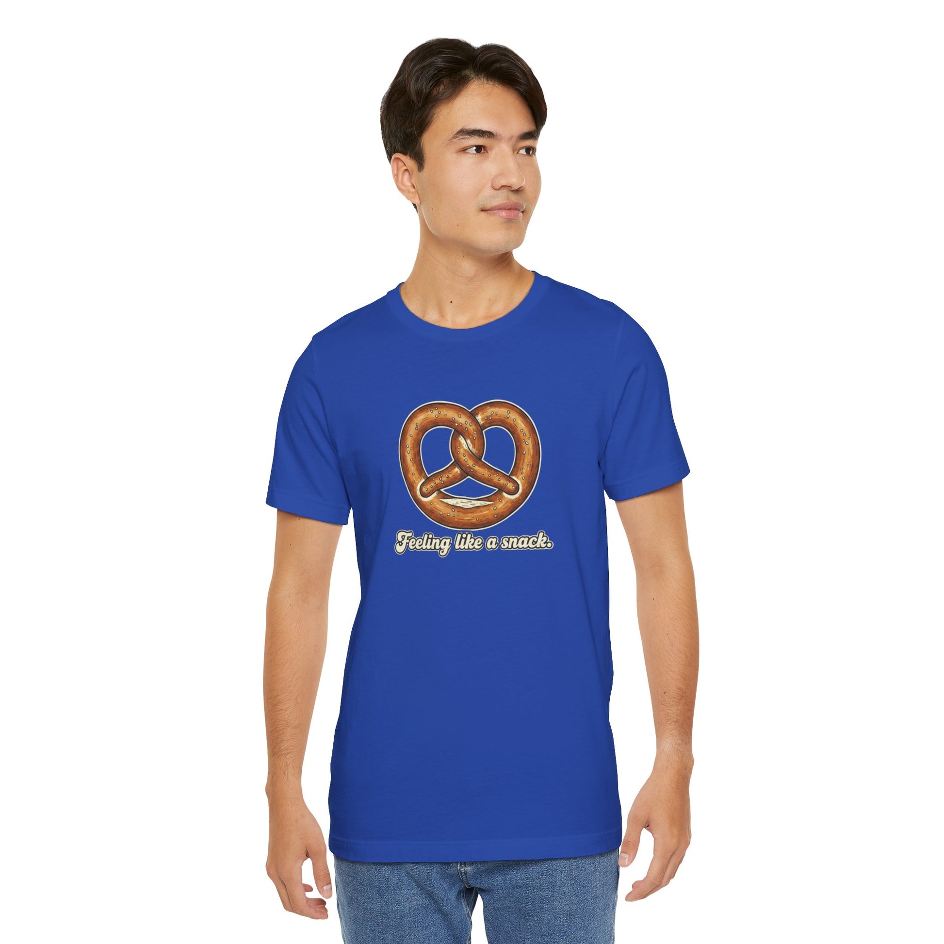 Man wearing a blue t-shirt with a pretzel graphic and text 'Feeling like a snack' on a white background