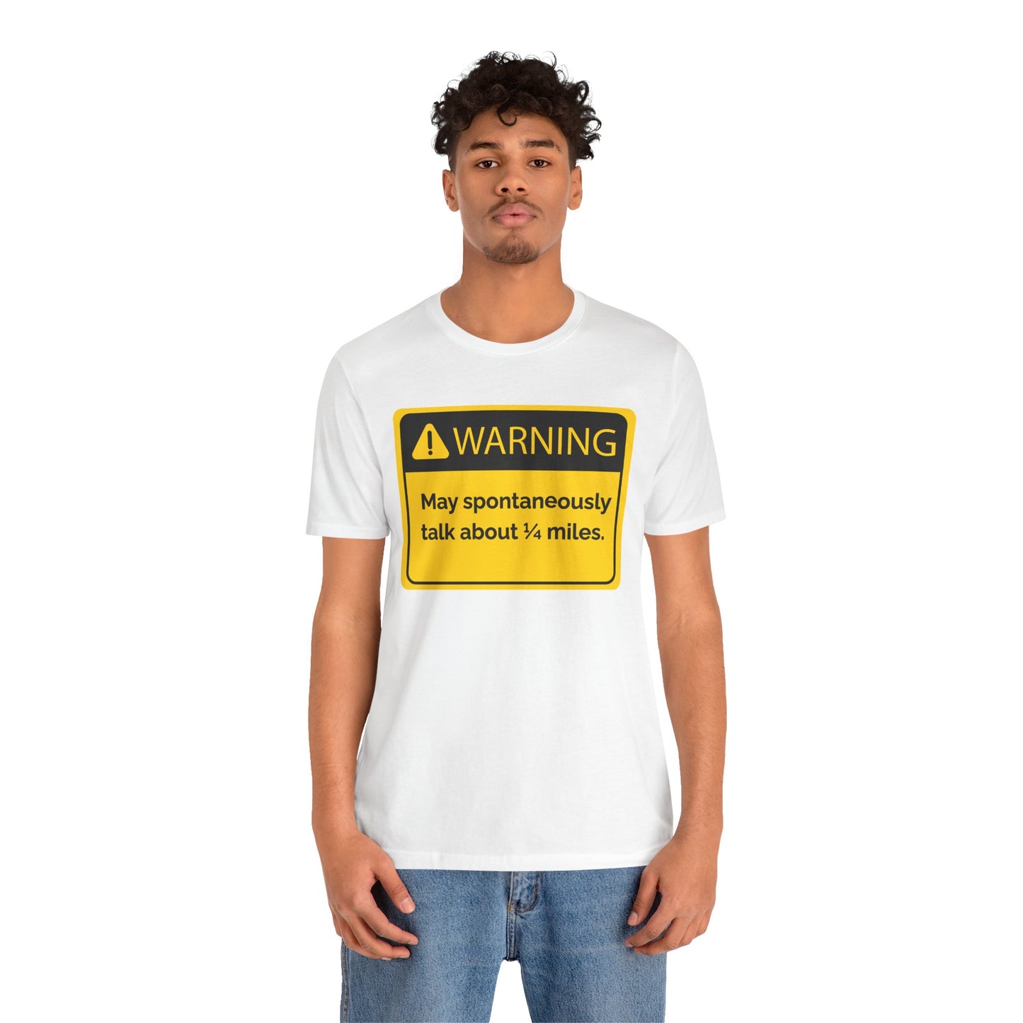 Person wearing a white t-shirt with a yellow warning sign 'WARNING May spontaneously talk about 1/4 miles' graphic.