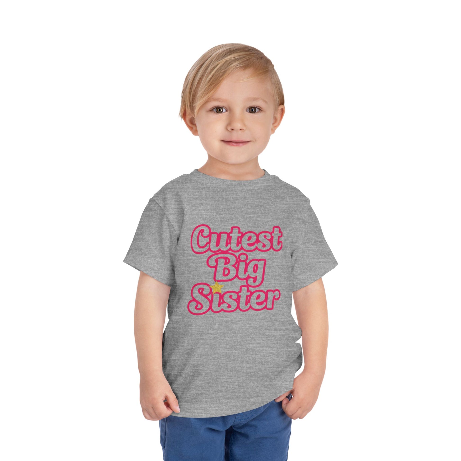 Child wearing a gray t-shirt with 'Cutest Big Sister' text on a white background