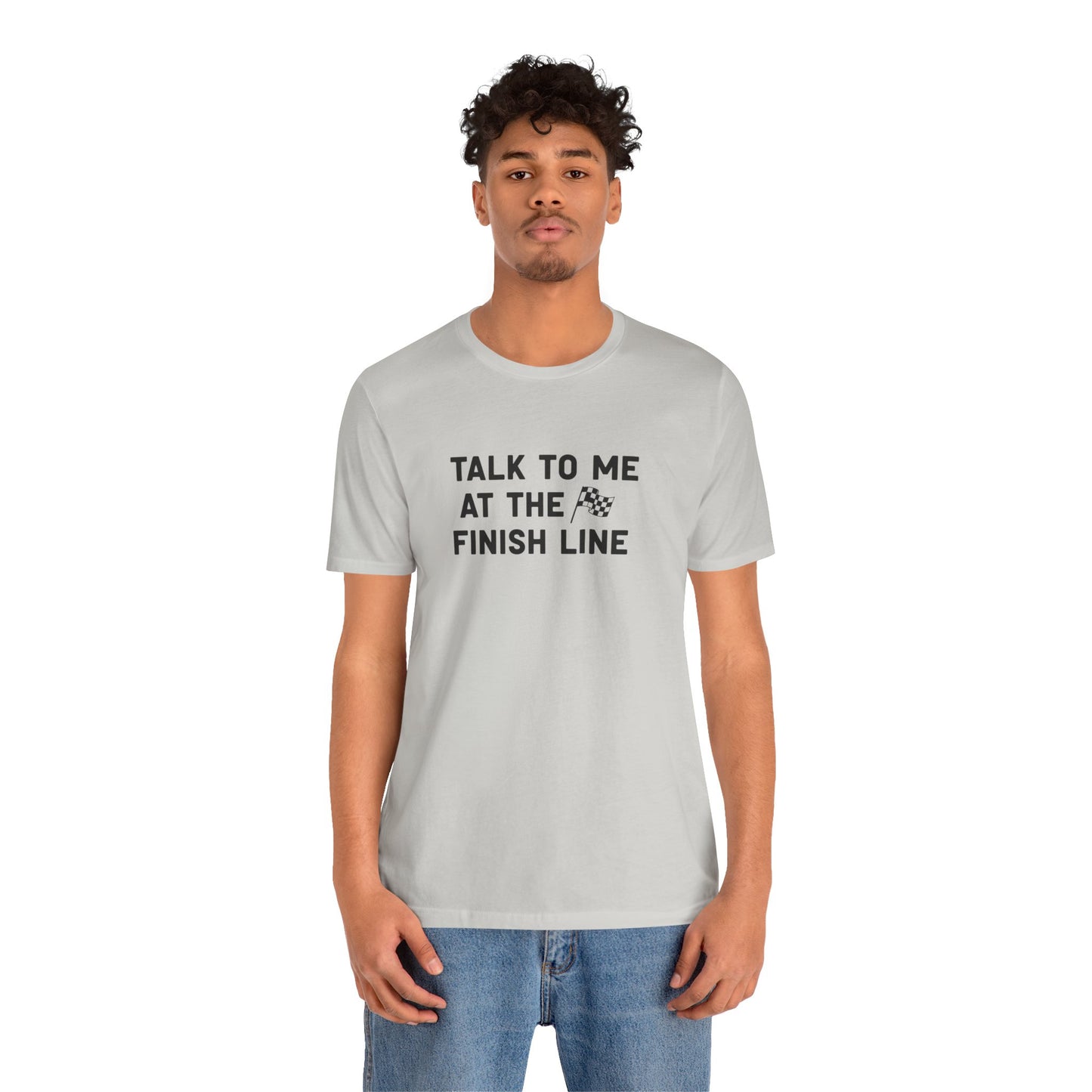 Person wearing a gray t-shirt with text 'Talk to me at the finish line' on a white background