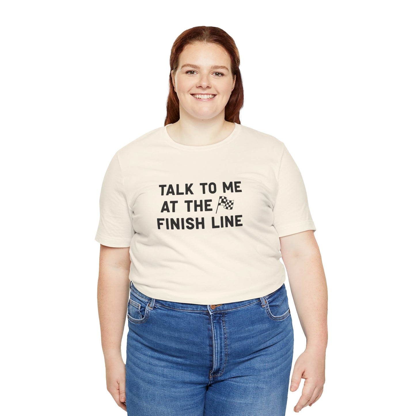 Person wearing a beige t-shirt with 'Talk to me at the finish line' text on a white background