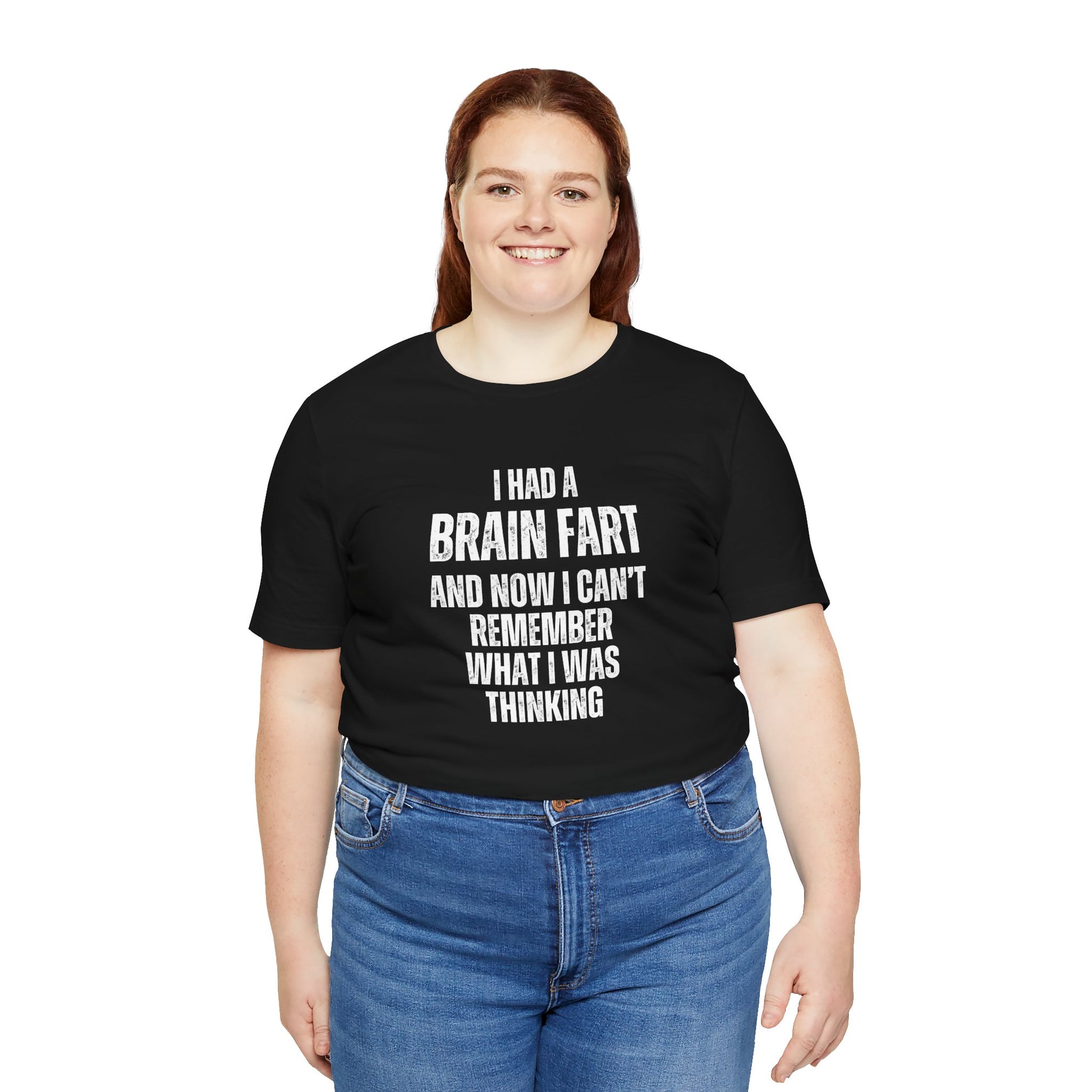 Person wearing a black t-shirt with humorous text 'I had a brain fart and now I can't remember what I was thinking' on a white background