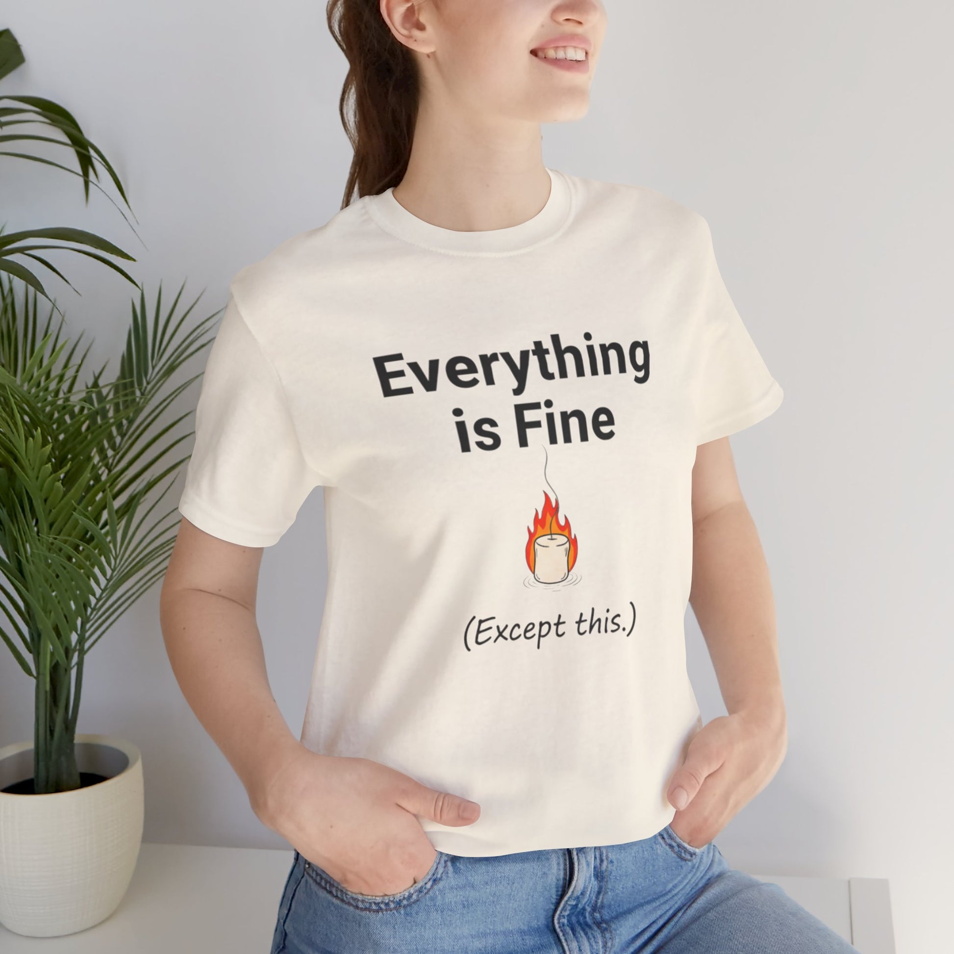 Person wearing a white t-shirt with 'Everything is Fine (Except this)' text, standing indoors.