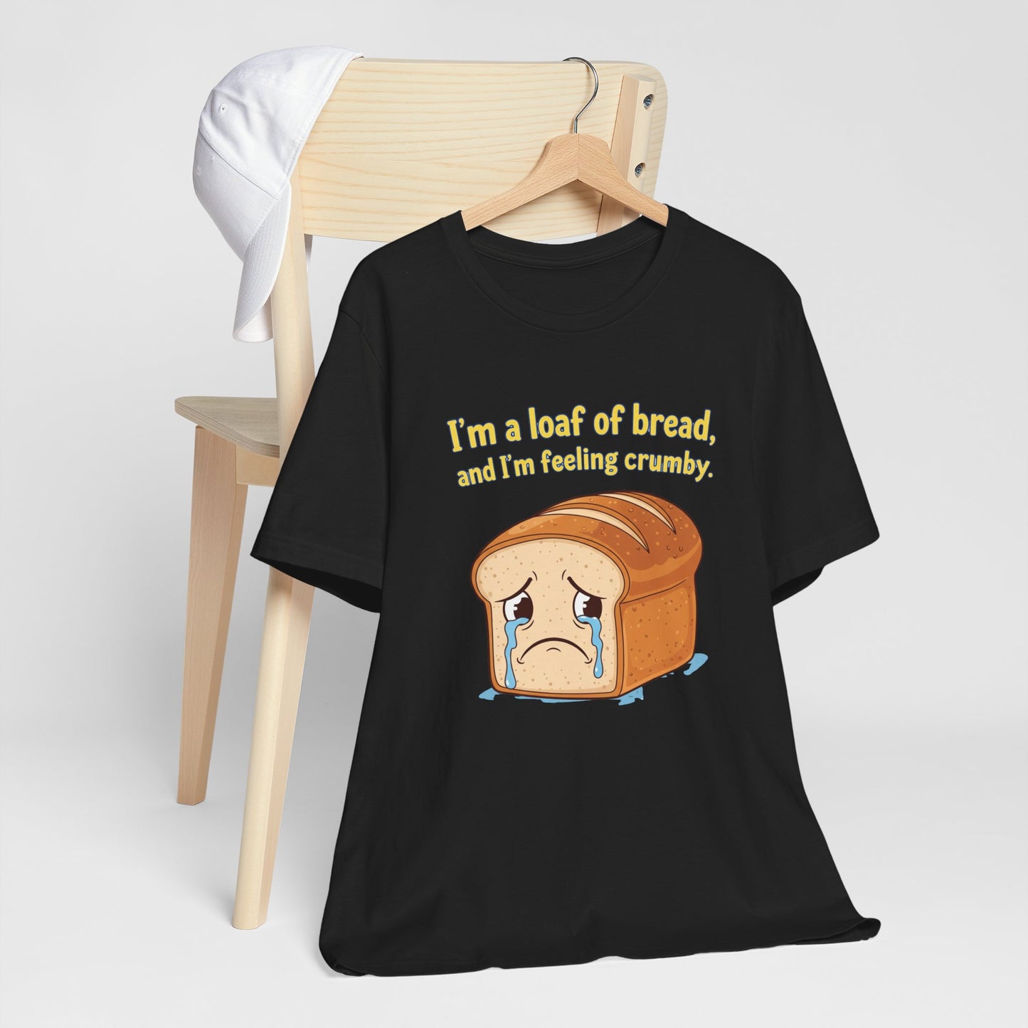 Black Bella+Canvas 3001 t-shirt with bread graphic and text on a white background. The text says, "I'm a loaf of bread, and I'm feeling crumby."
