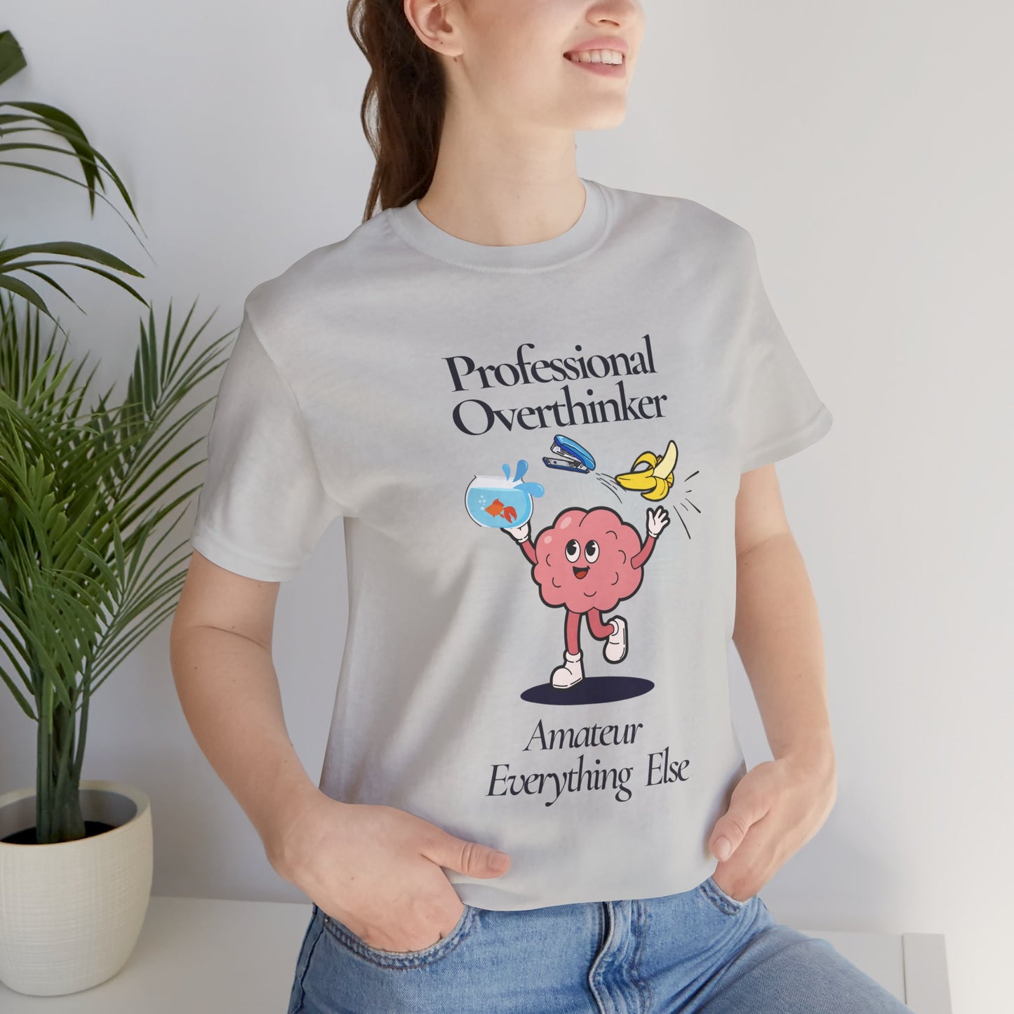 Person wearing a t-shirt with a brain graphic and text 'Professional Overthinker, Amateur Everything Else' in a casual setting