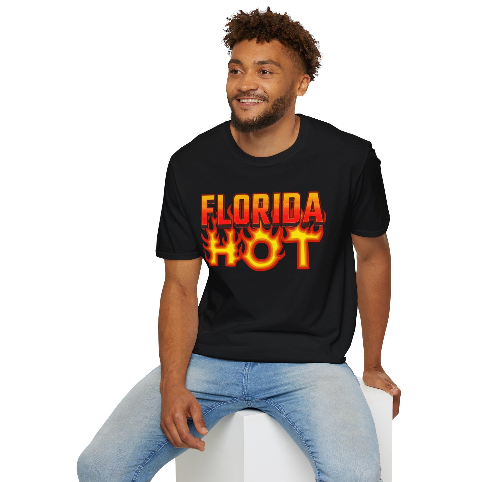 Man wearing a black t-shirt with 'FLORIDA HOT' text, sitting on a white stool against a white background