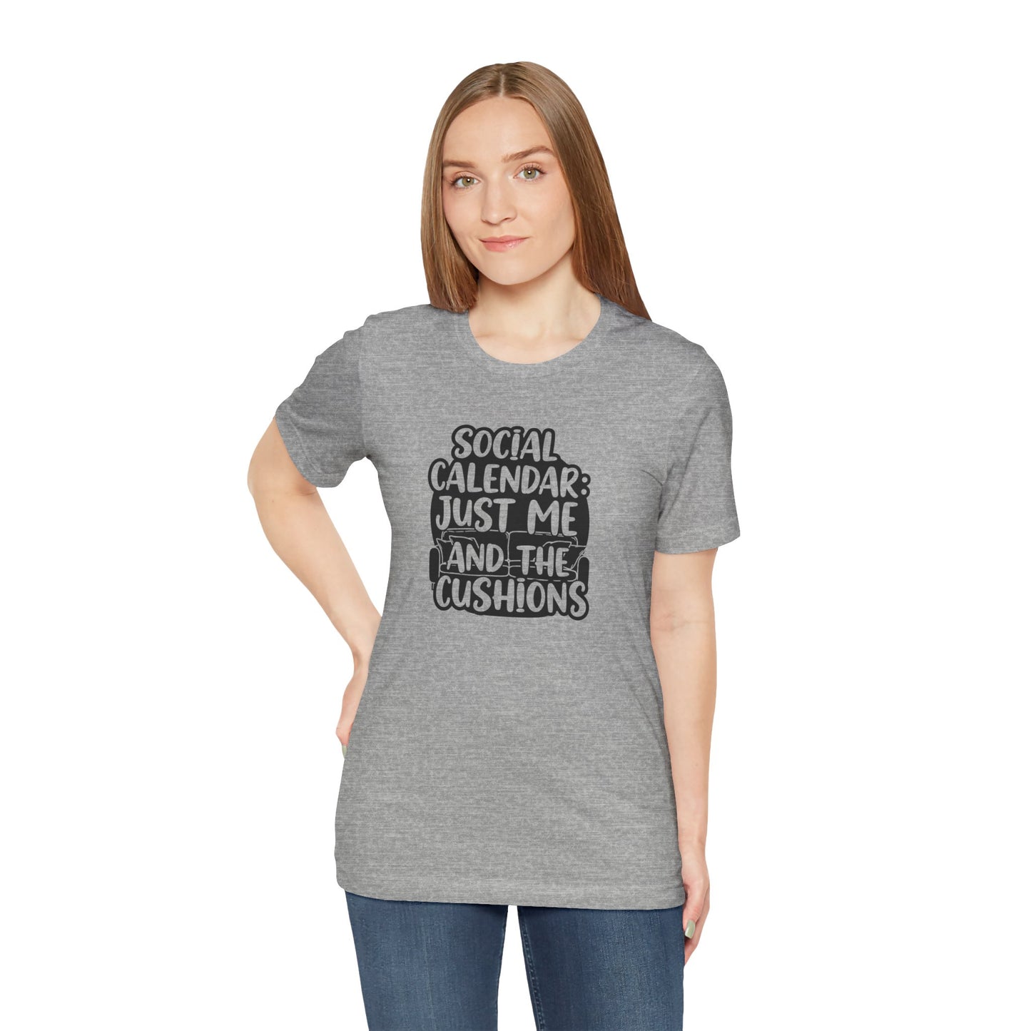 Woman wearing a gray t-shirt with text 'Social calendar: Just me and the cushions' on a white background