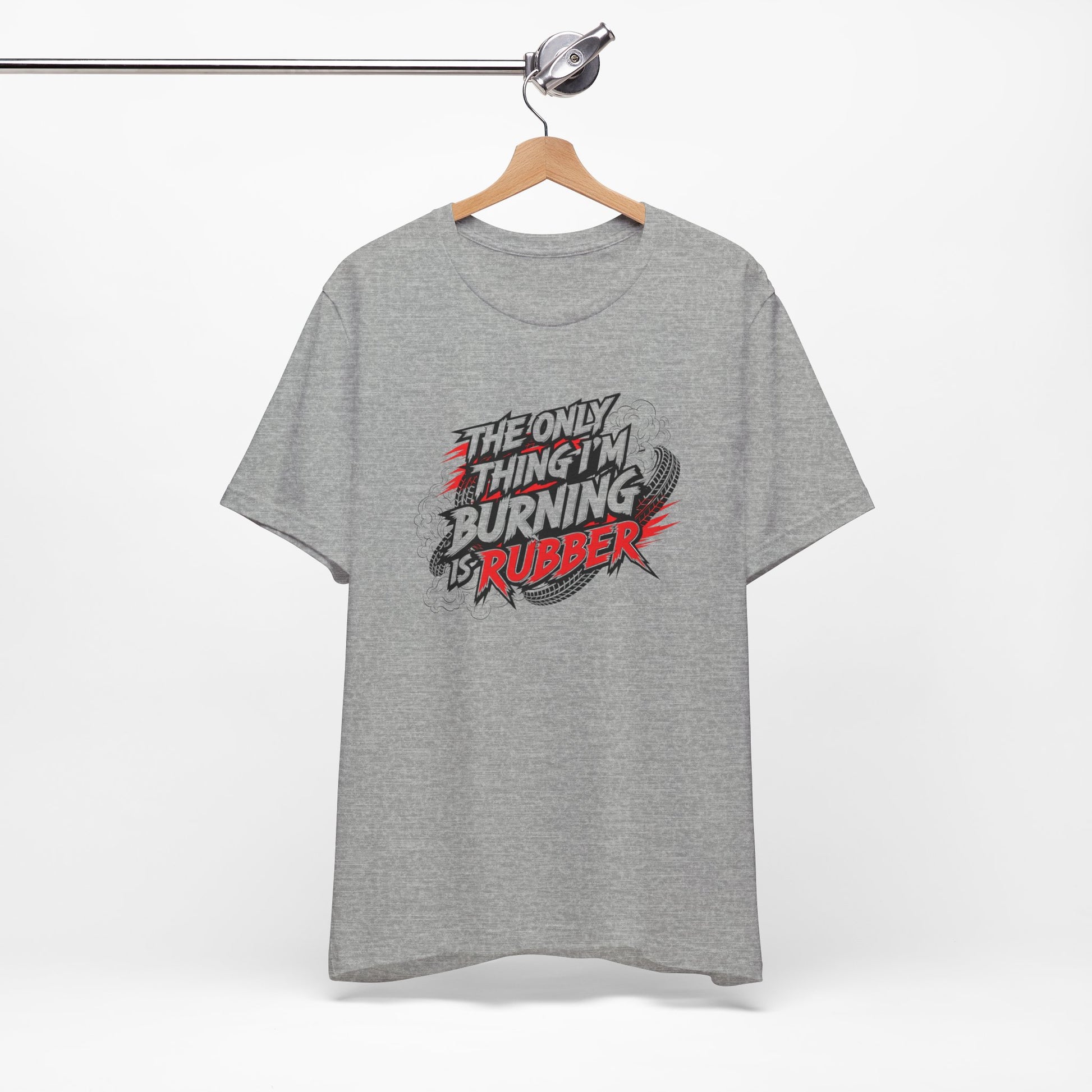Gray t-shirt with a graphic design and text 'The only thing I'm burning is rubber' on a hanger against a white background