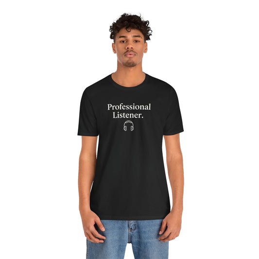 Person wearing a black Bella+Canvas 3001 t-shirt with 'Professional Listener' text and headphones graphic on a white background