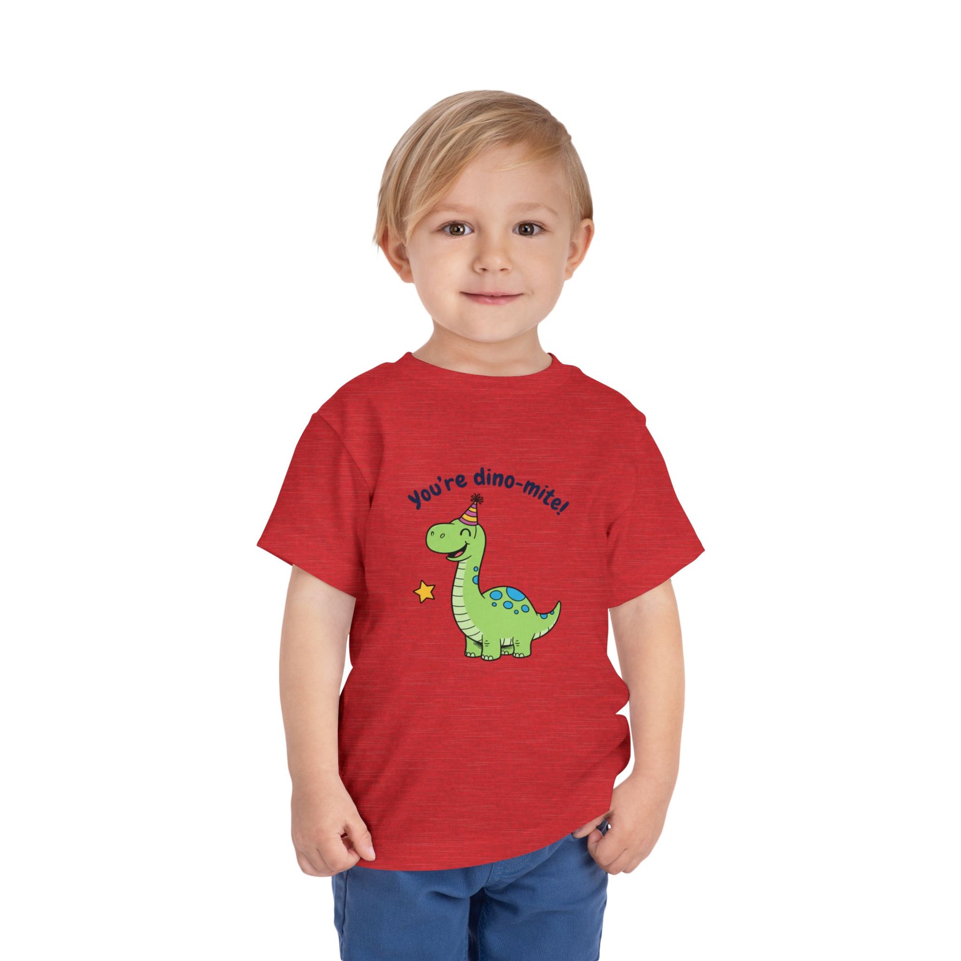 Child wearing a red t-shirt with a dinosaur graphic and text on a white background