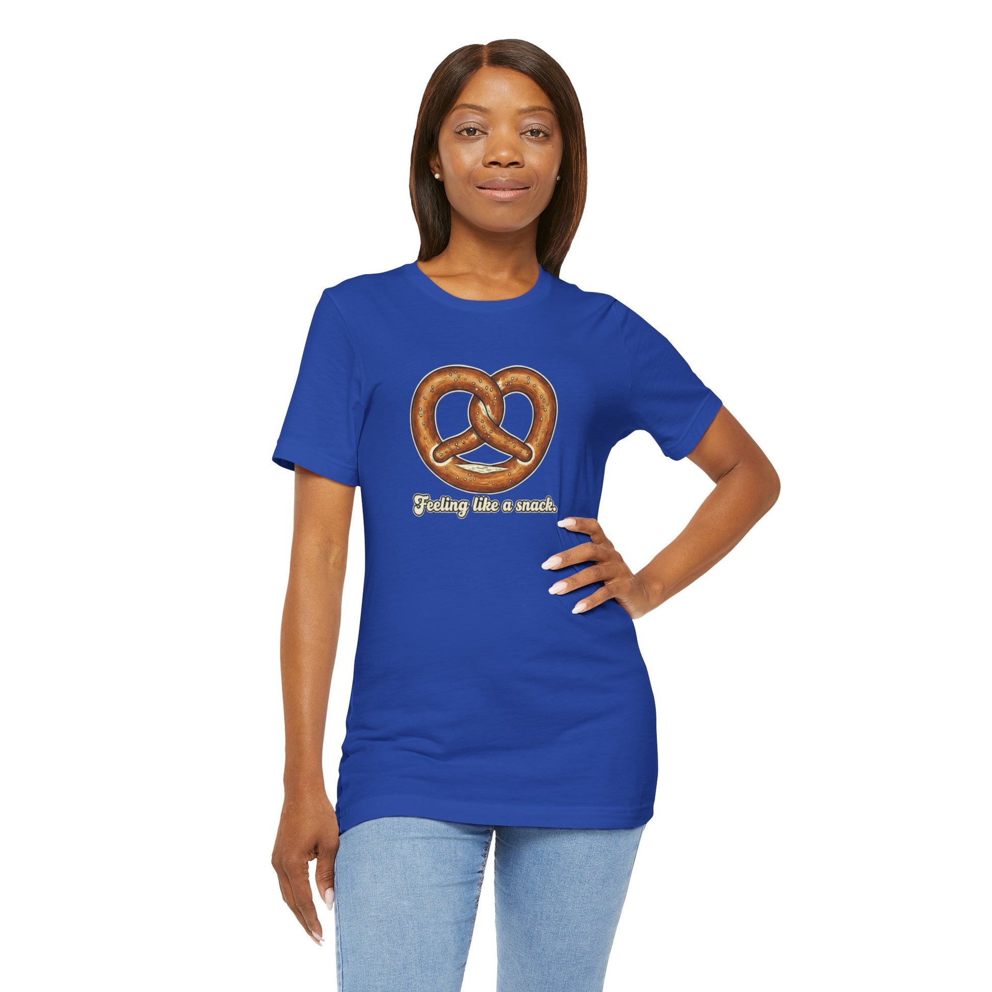 Woman wearing a blue t-shirt with a pretzel graphic and text 'Feeling like a snack' on a white background