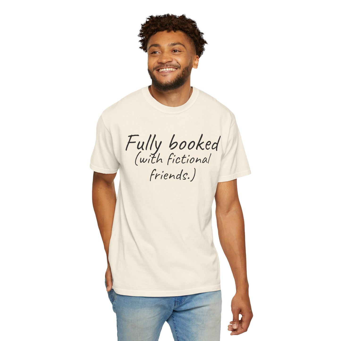 Man wearing a cream t-shirt with text 'Fully booked (with fictional friends)' on a white background