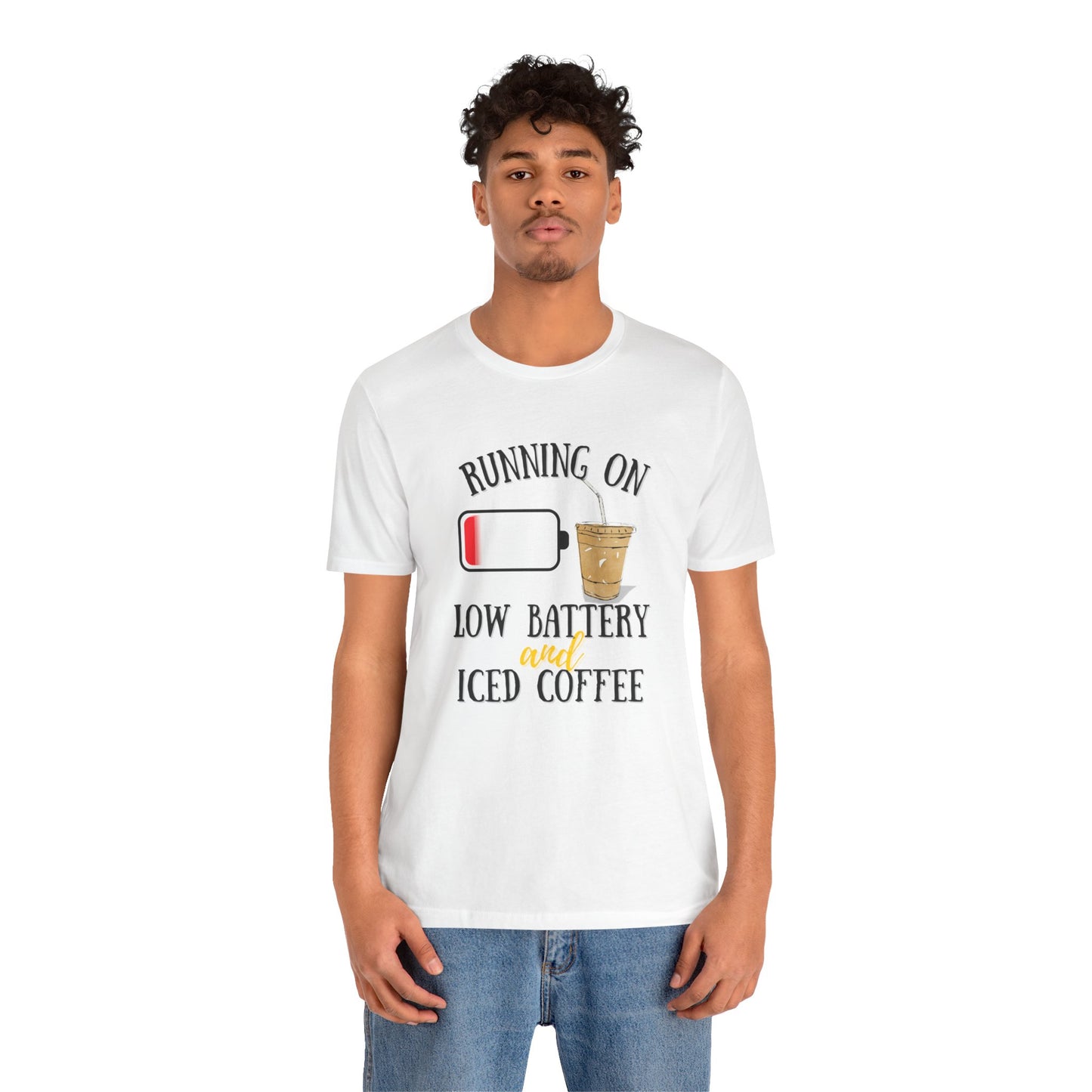 Person wearing a white t-shirt with a humorous graphic and text 'Running on low battery and iced coffee' on a white background