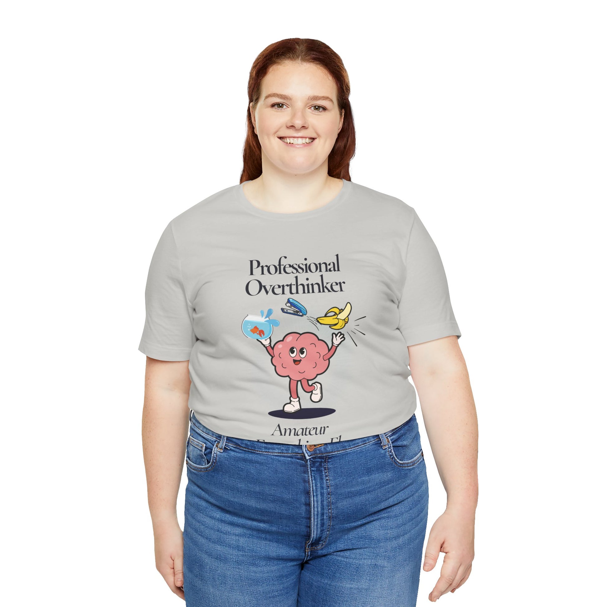 Person wearing a gray t-shirt with a brain graphic and text 'Professional Overthinker, Amateur Everything Else' on a white background