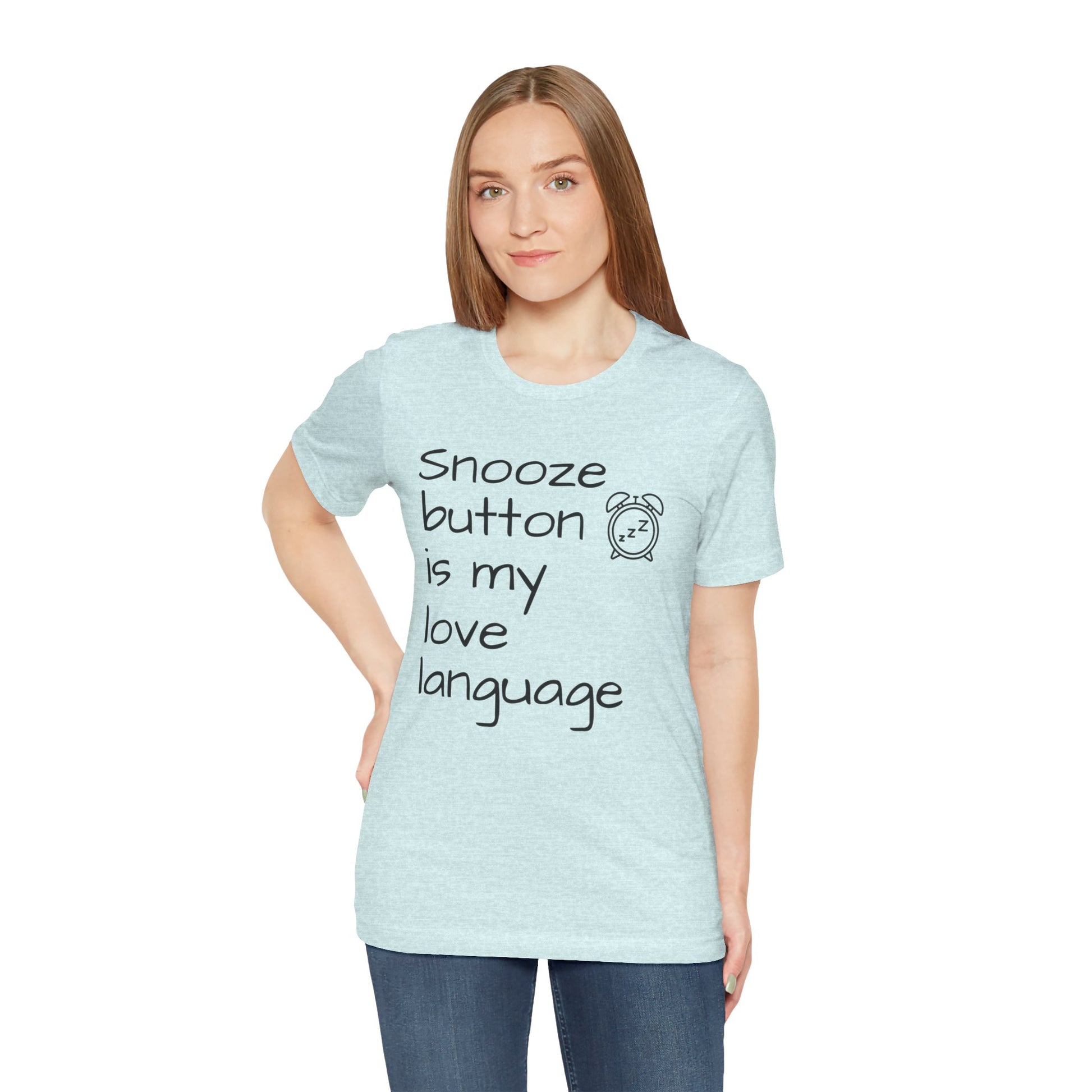 Woman wearing a light blue t-shirt with text 'Snooze button is my love language' on a white background