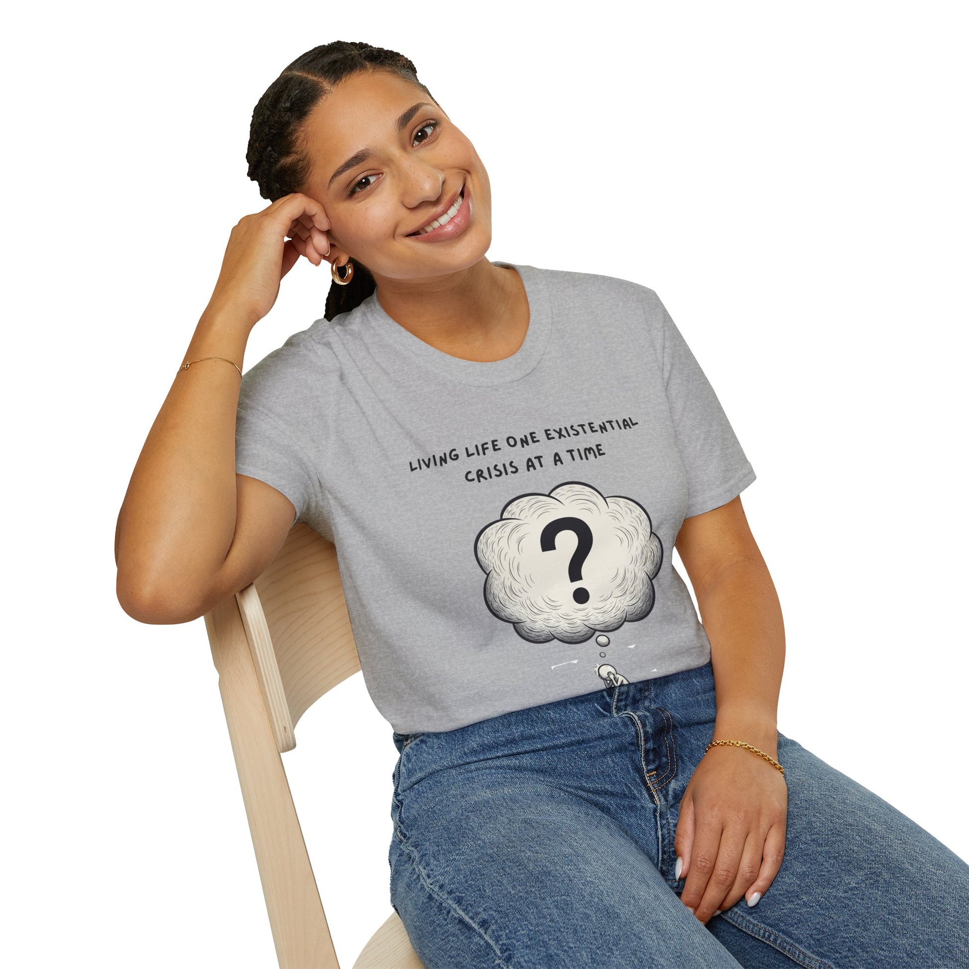 Person wearing a gray t-shirt with a cloud graphic and text 'Living Life One Existential Crisis At A Time', sitting on a chair.