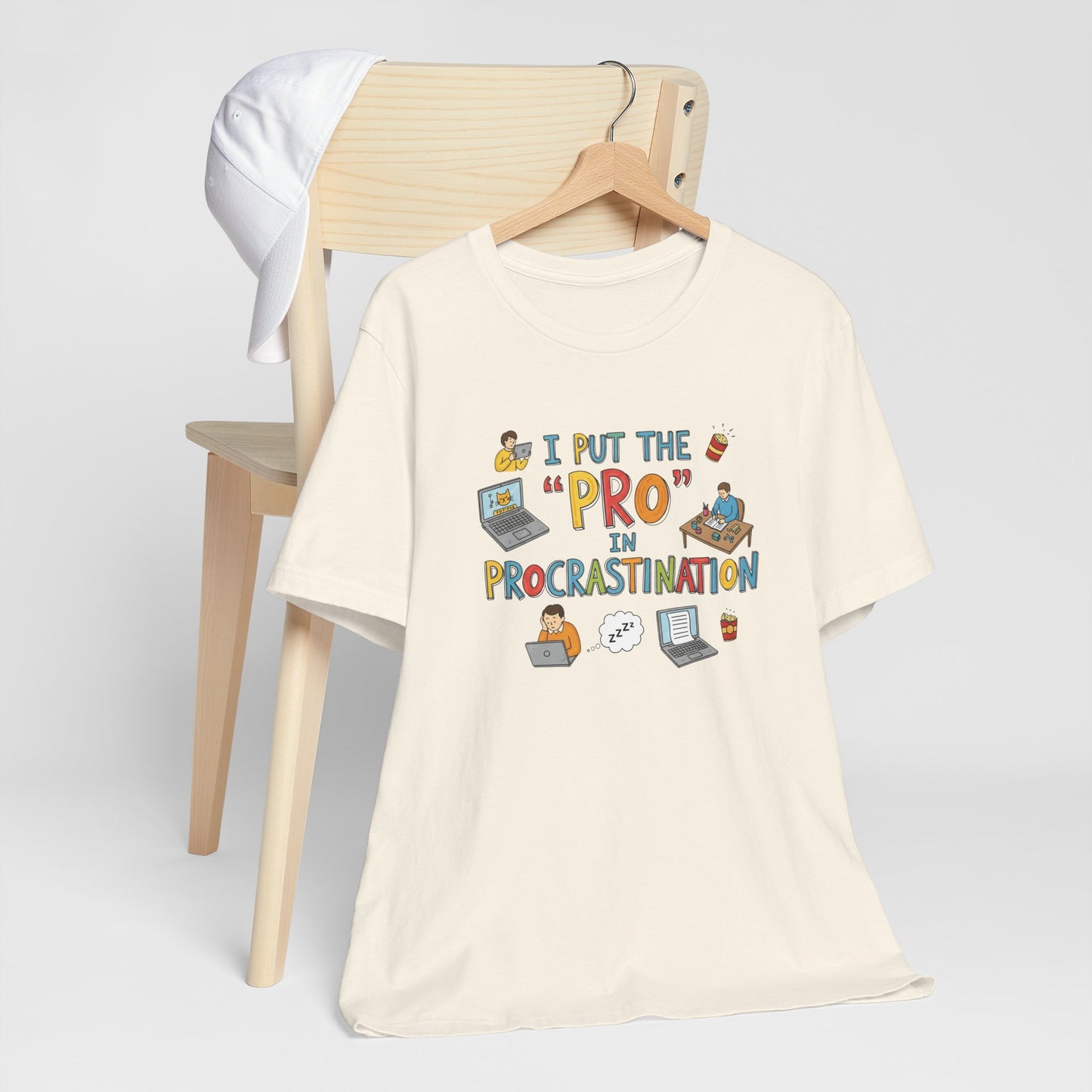 Beige t-shirt with humorous design on a wooden chair against a white background
