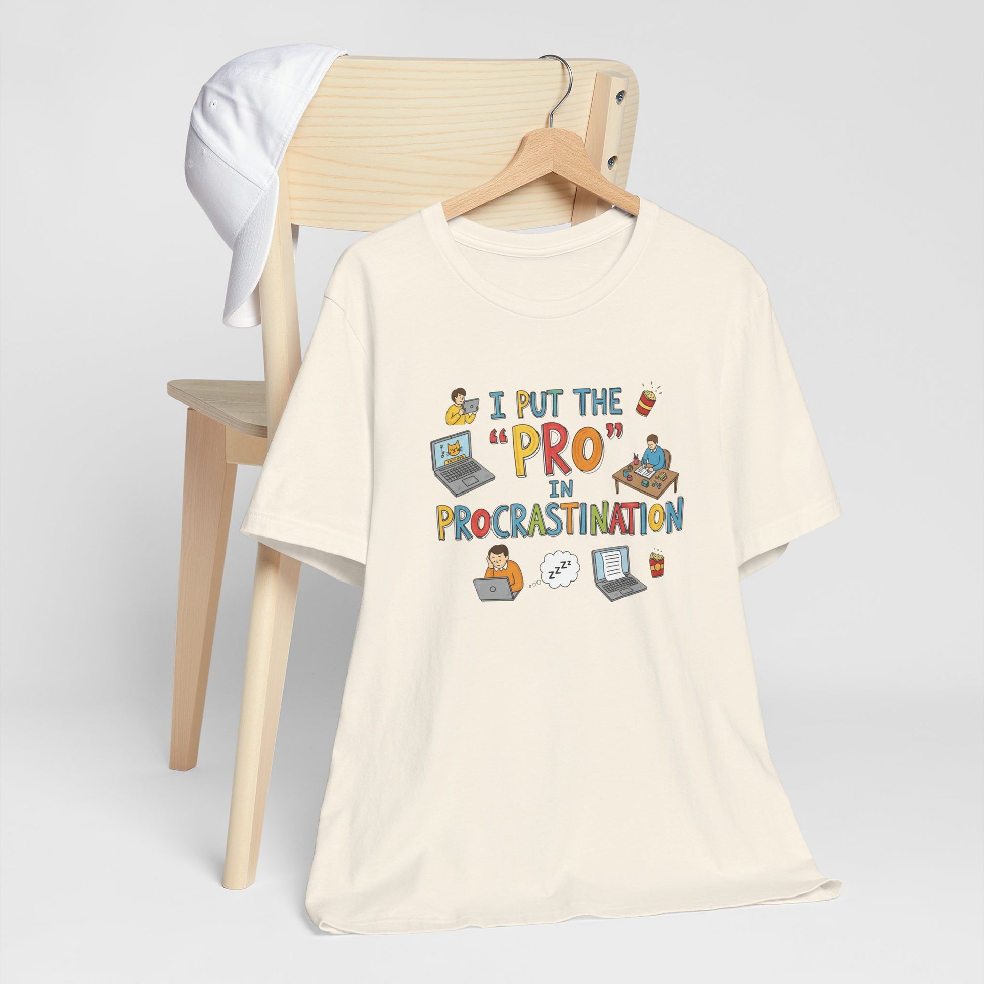 Beige t-shirt with humorous design on a wooden chair against a white background