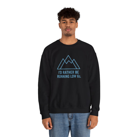 Person wearing a black sweatshirt with a mountain graphic and text 'I'd rather be running low 6s' on a white background